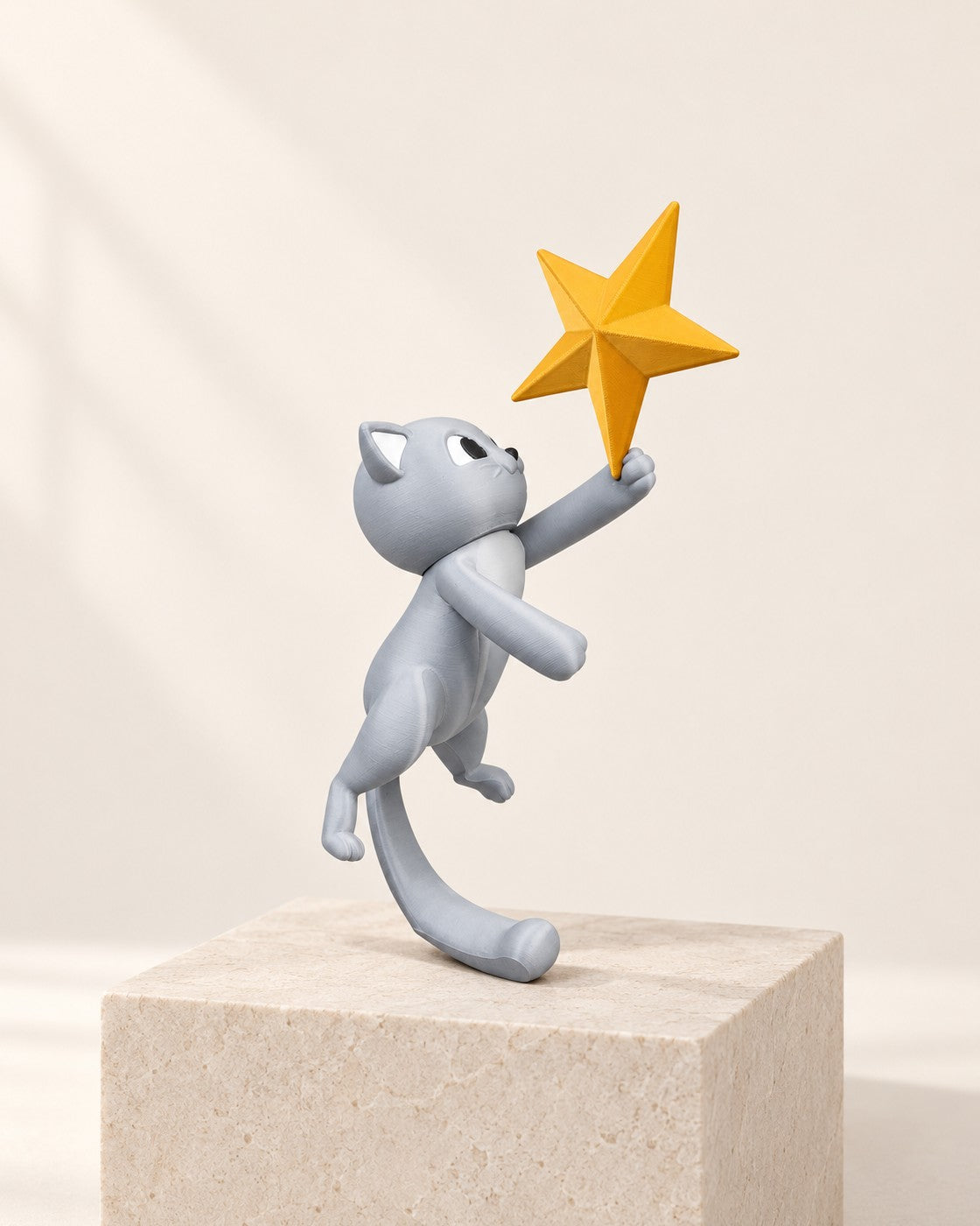 Cat Christmas Tree Topper on a pale limestone plinth, soft studio light