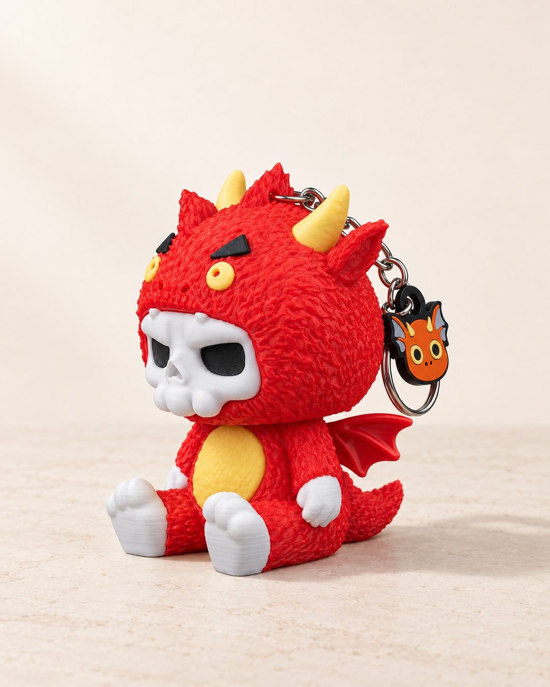Dragon Skull Keyring: A small red dragon character with a white skull face
