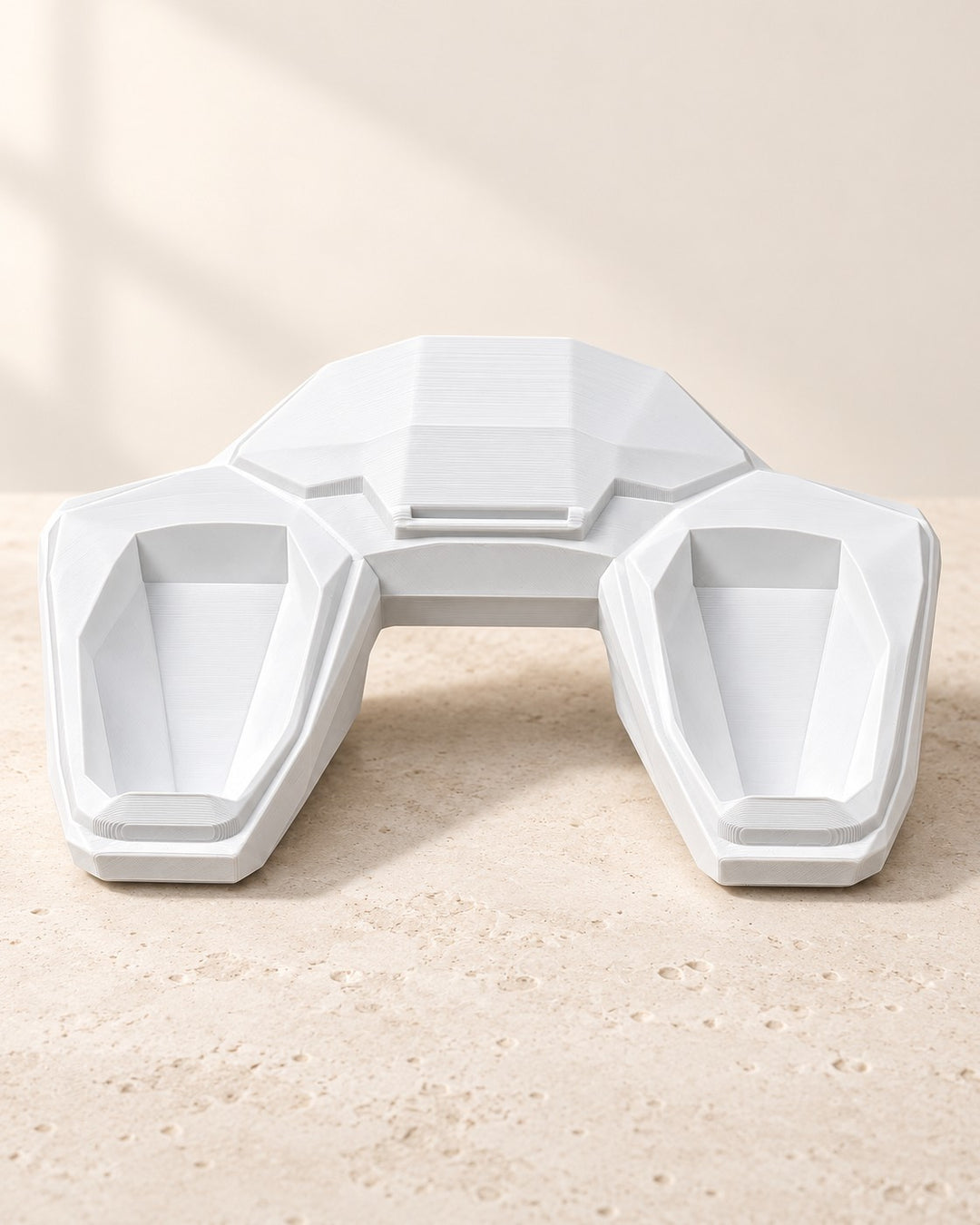 Faceted Controller Stand: Angled sci-fi cradles that hold a controller within reach
