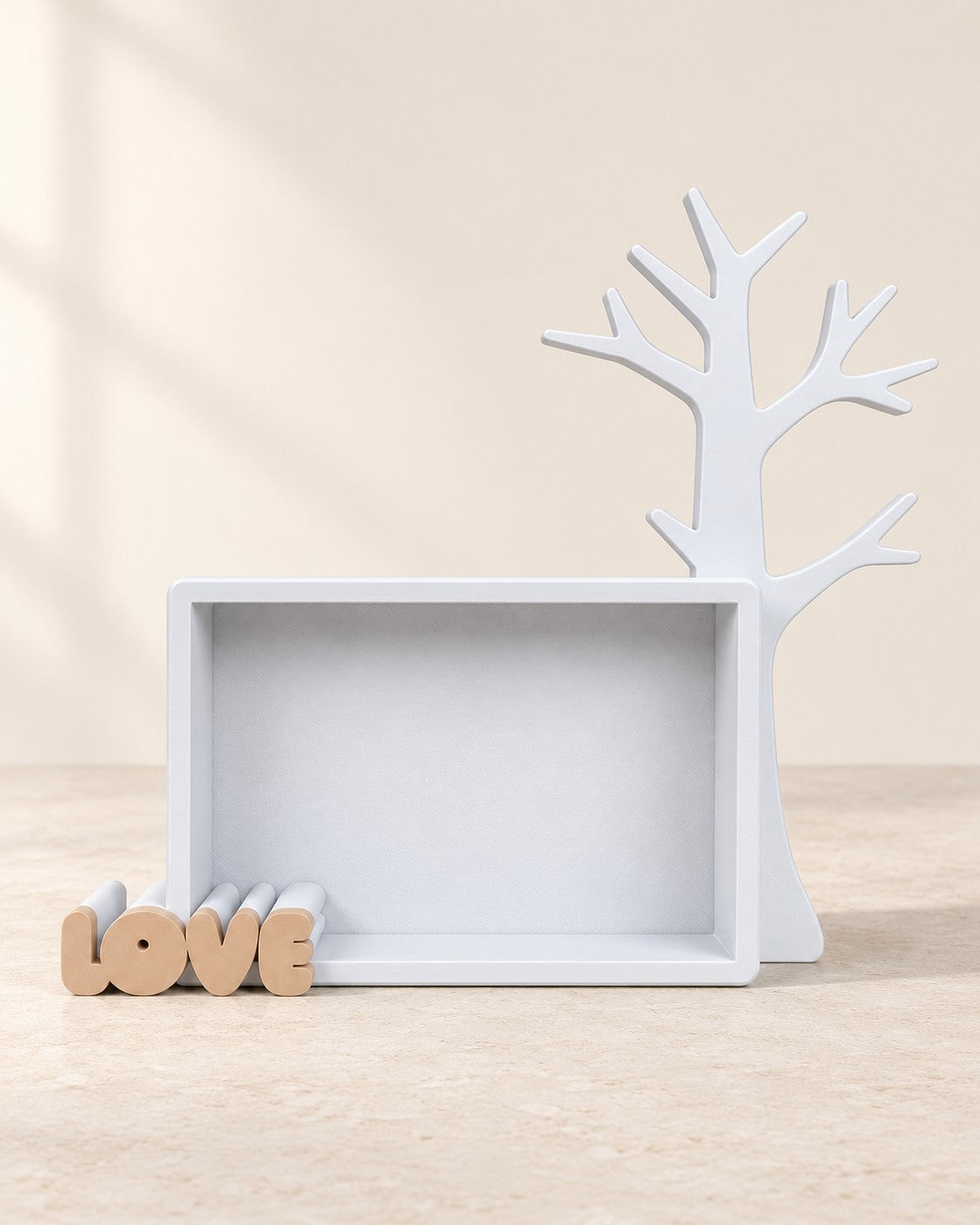 Keepsake Tree on a pale limestone plinth, soft studio light