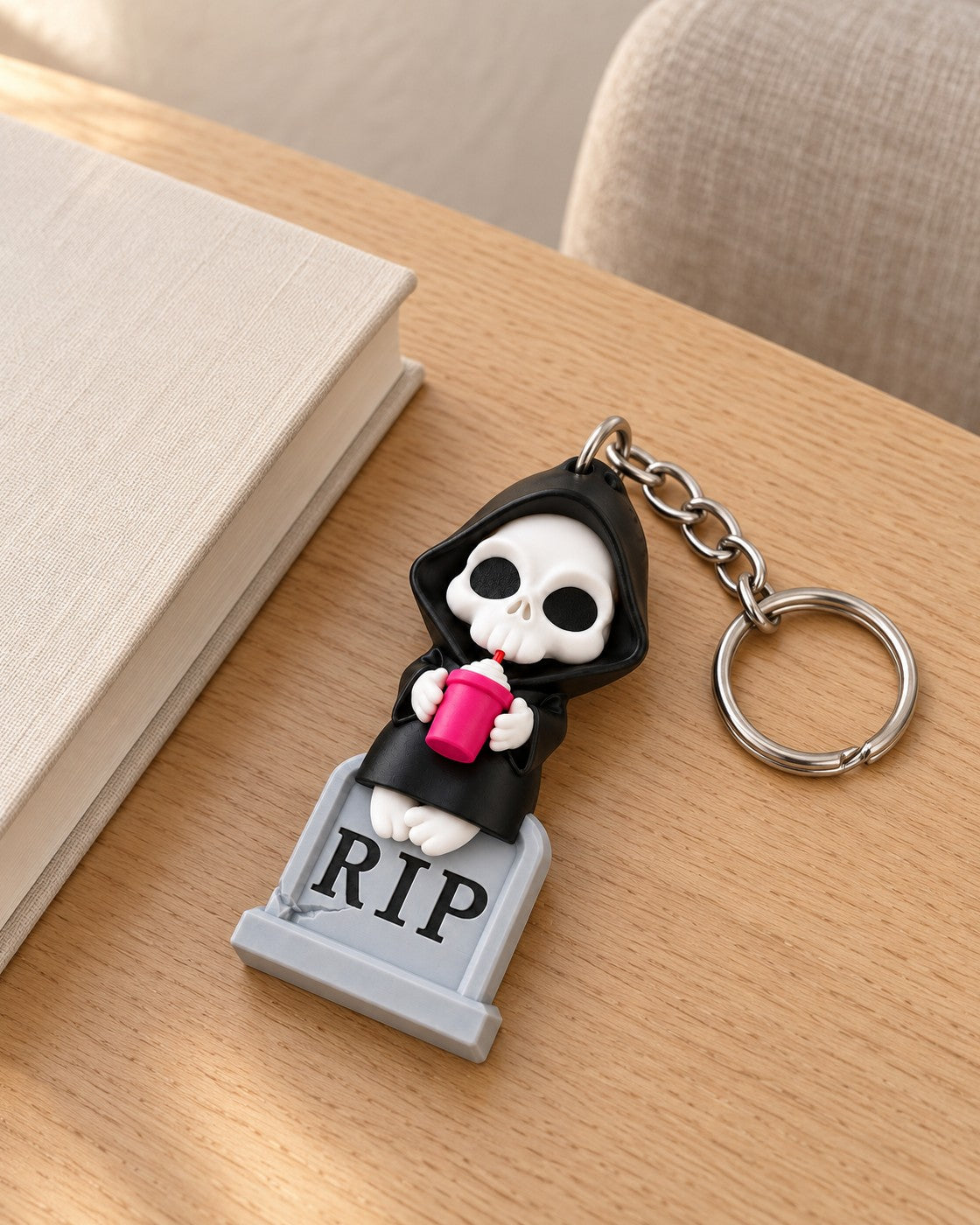 Sweet Rest Reaper Keyring in a calm, softly lit interior, shown at true scale