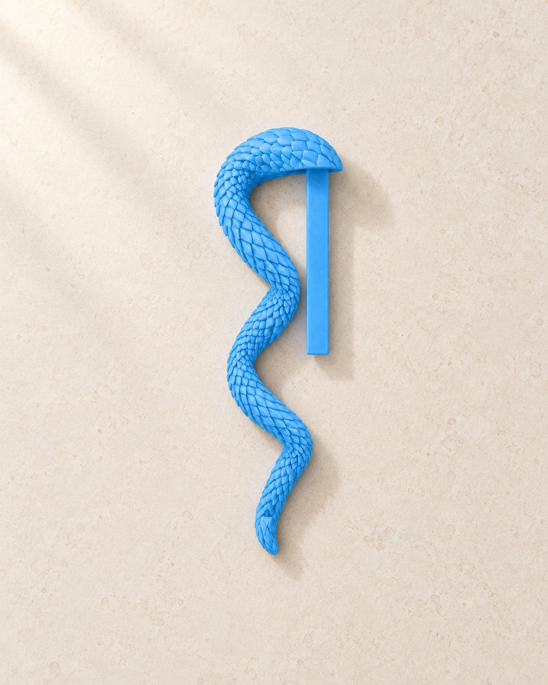 Dragon Tail Bookmark on a pale limestone plinth, soft studio light