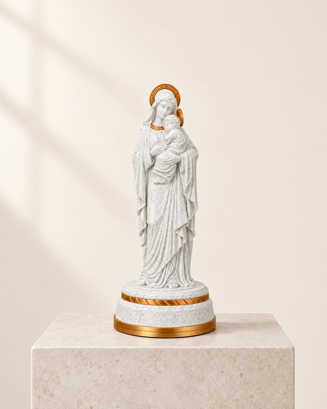 Mary and Child Statue on a pale limestone plinth, soft studio light