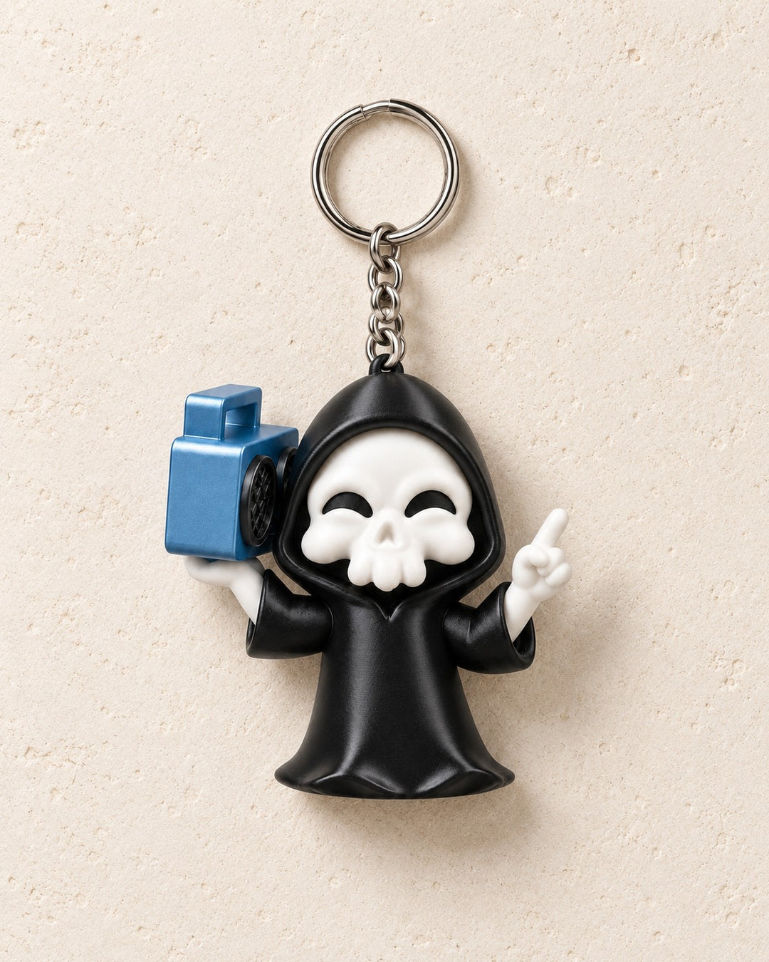 Groove Reaper Keyring: Smiling hooded skull carrying a blue boombox