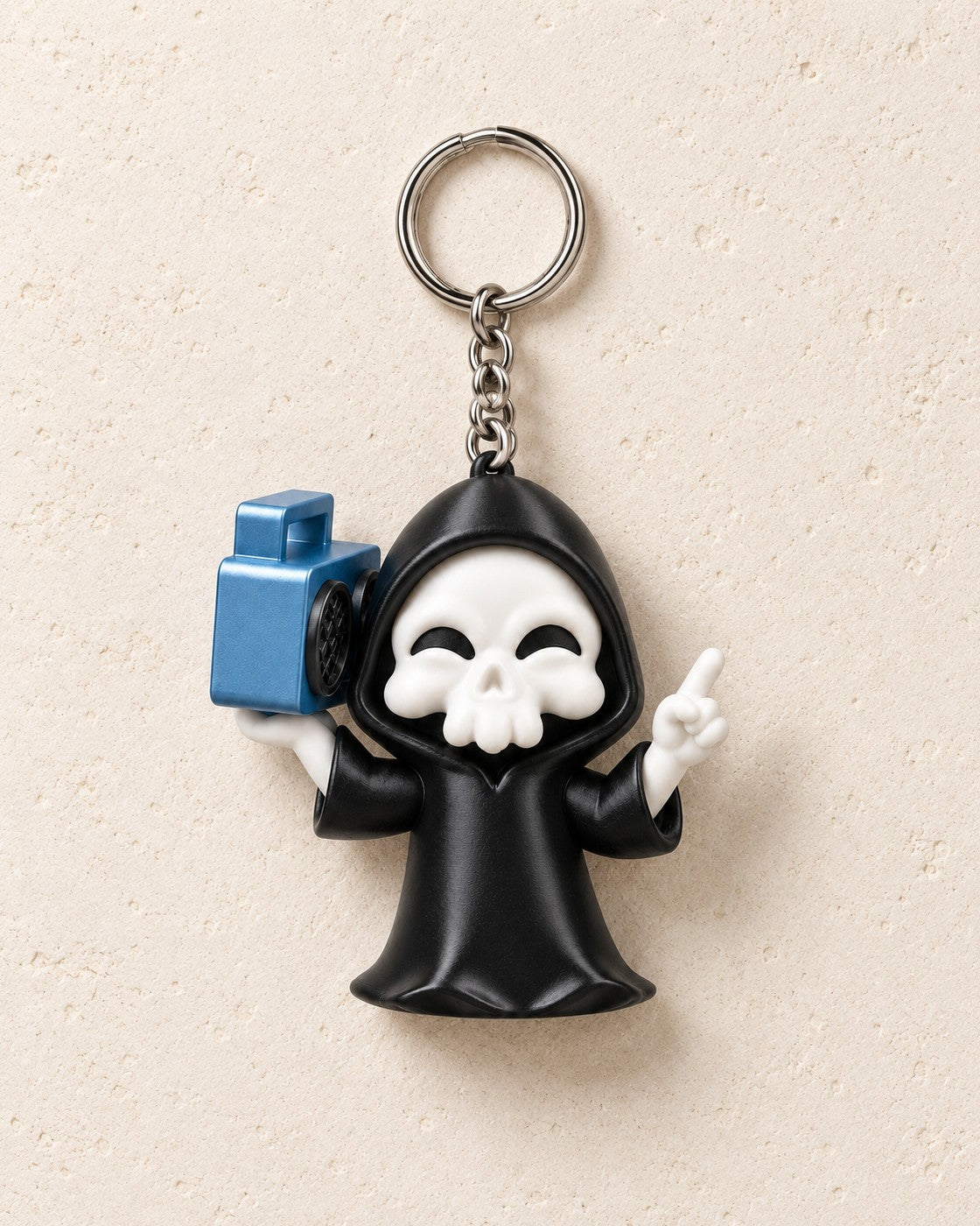 Groove Reaper Keyring on a pale limestone plinth, soft studio light