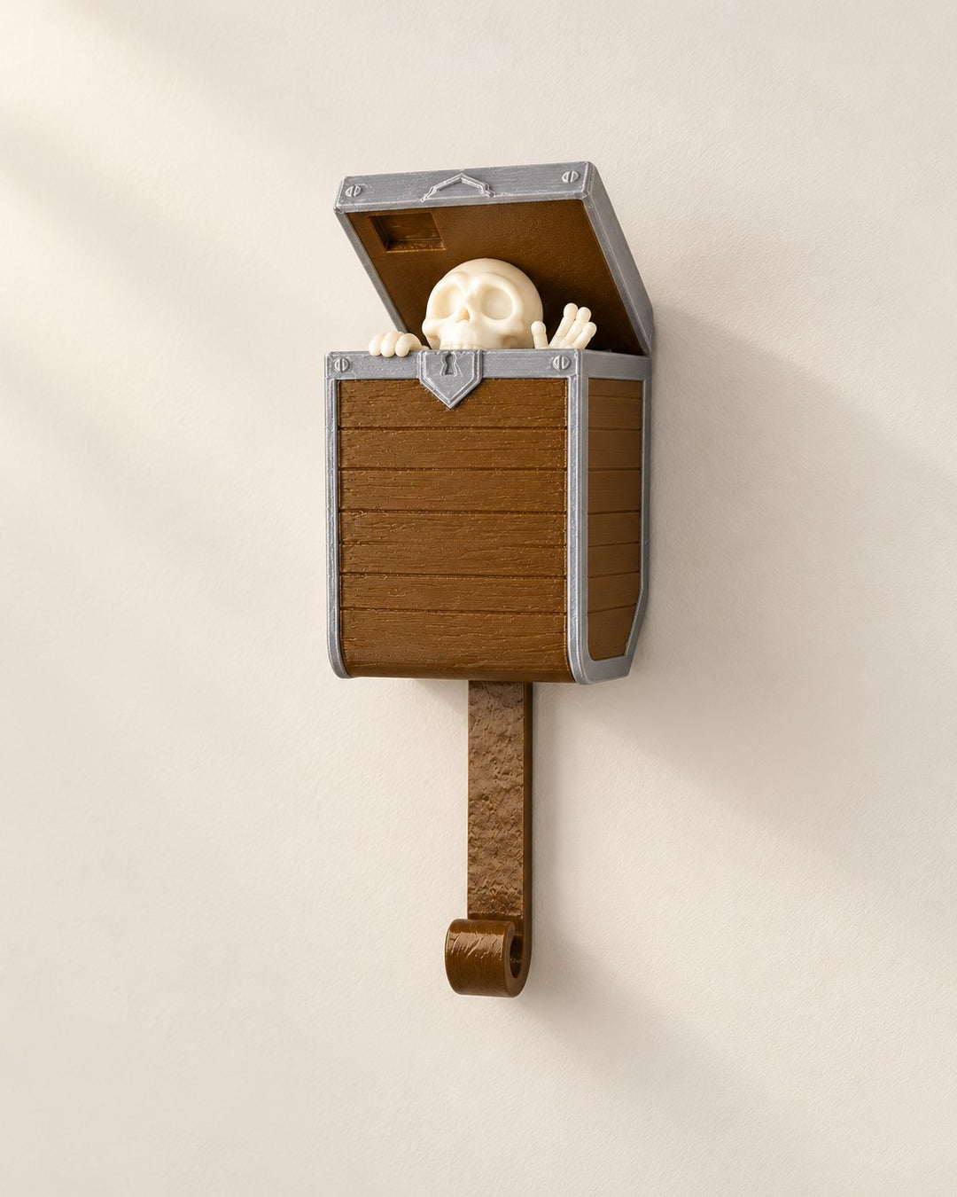 Pop-Up Skeleton Key Holder: Wall hook where a little skeleton rises from a treasure chest
