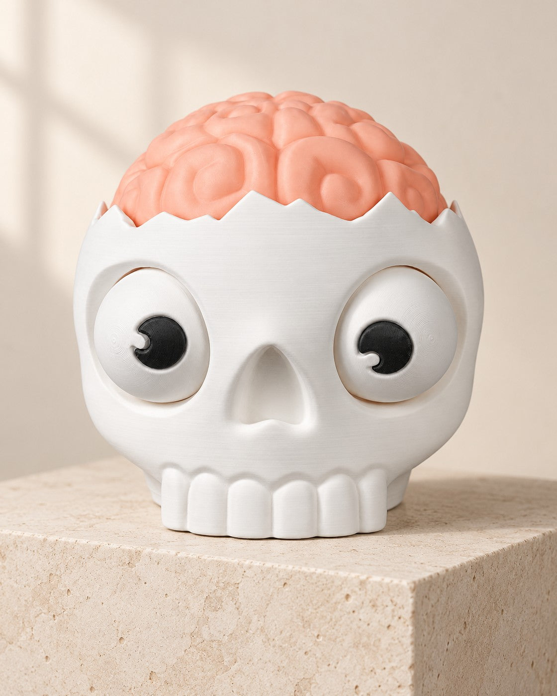 Brain Skull Candy Bowl on a pale limestone plinth, soft studio light