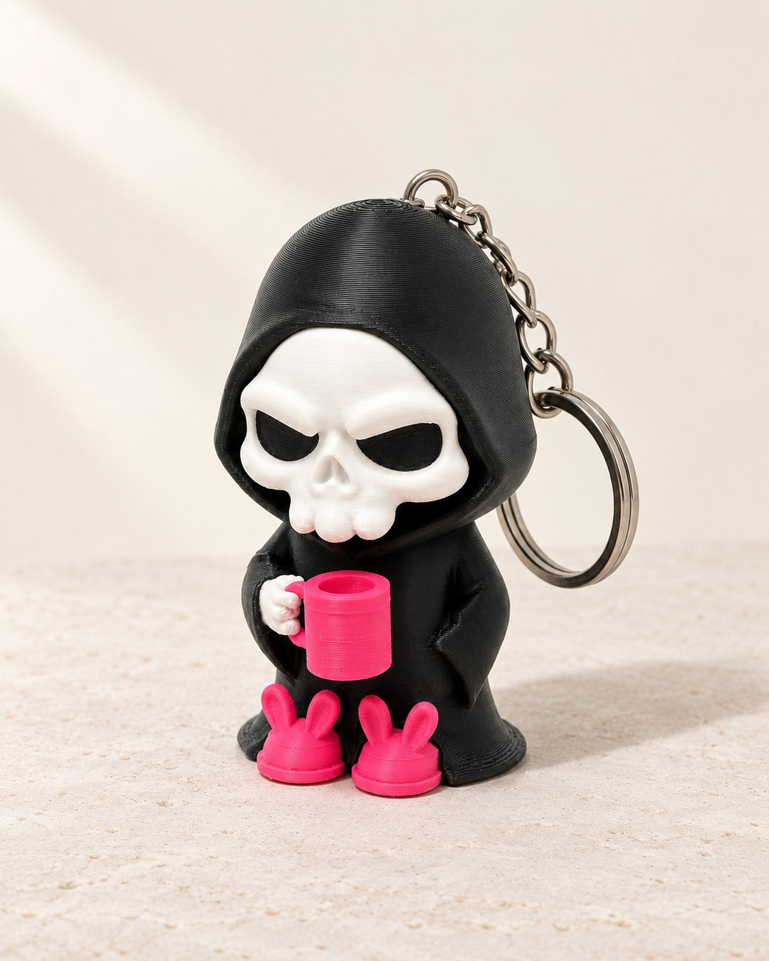 Coffee Break Reaper Keyring: Hooded reaper with a mug and bunny slippers, on a metal keyring