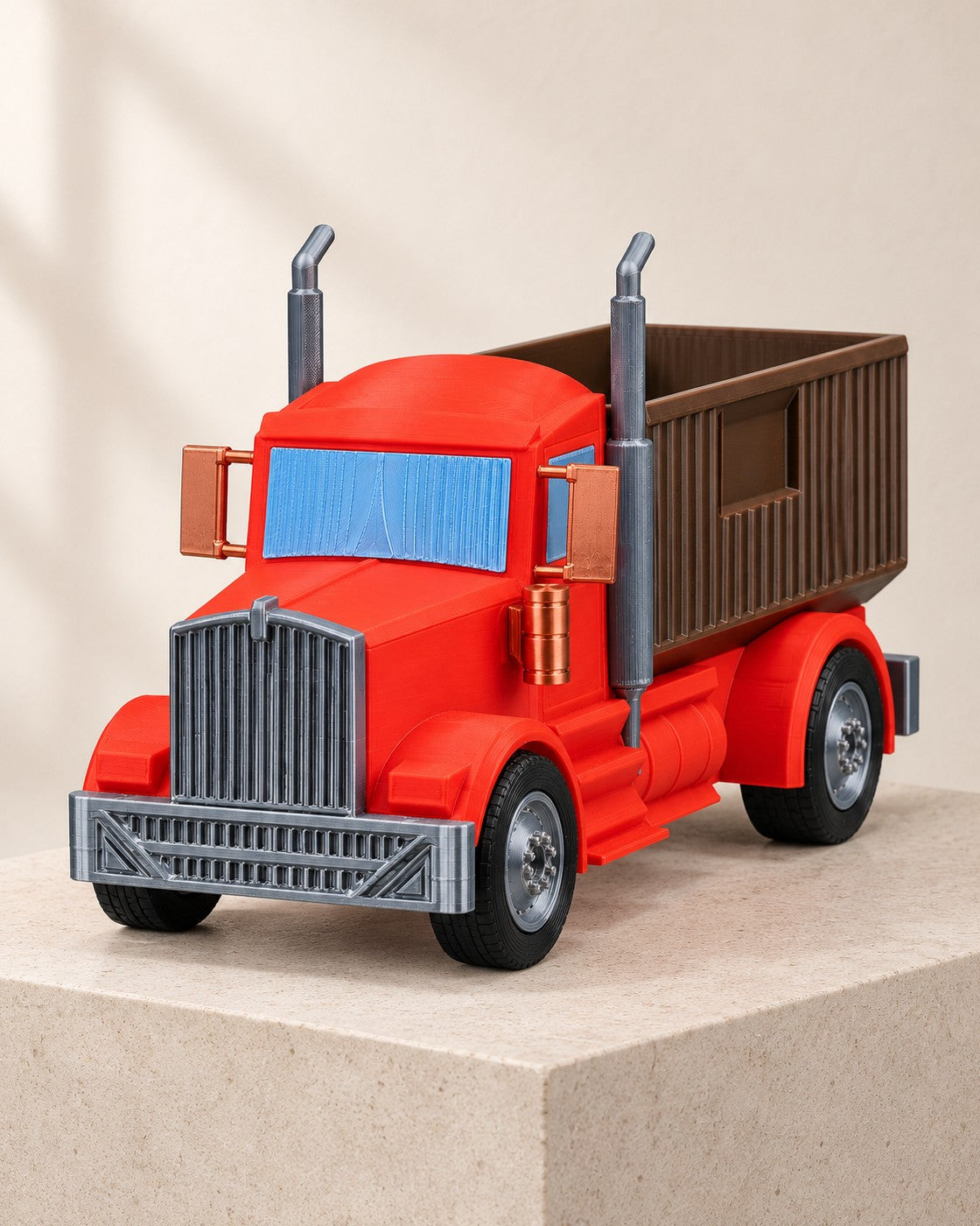 Tipper Truck Planter on a pale limestone plinth, soft studio light