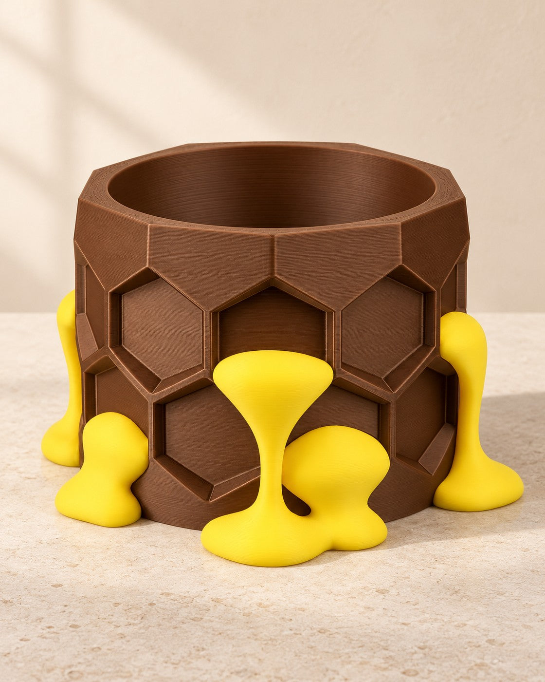 Honeycomb Plant Pot on a pale limestone plinth, soft studio light