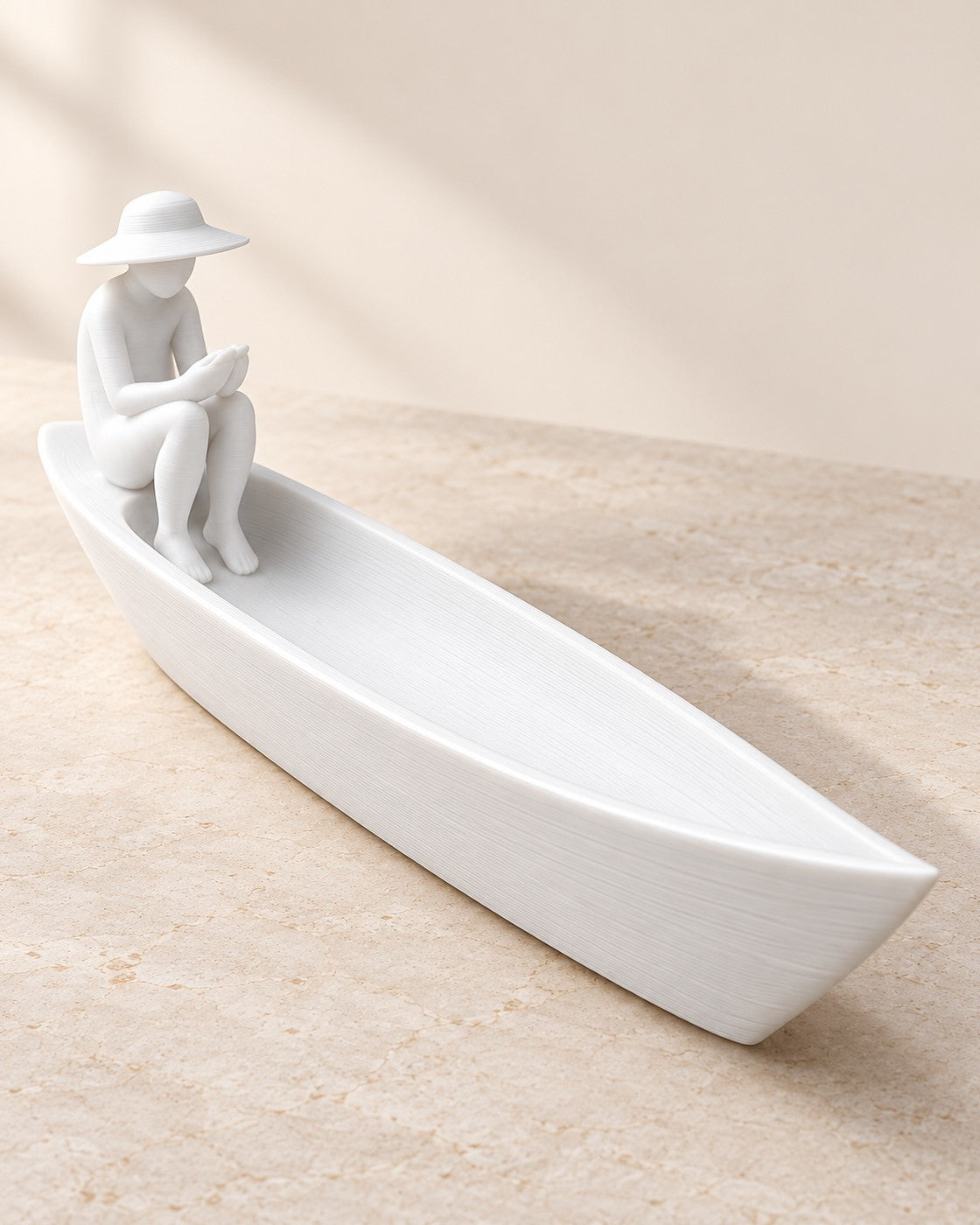 Fisherman Boat Incense Holder on a pale limestone plinth, soft studio light