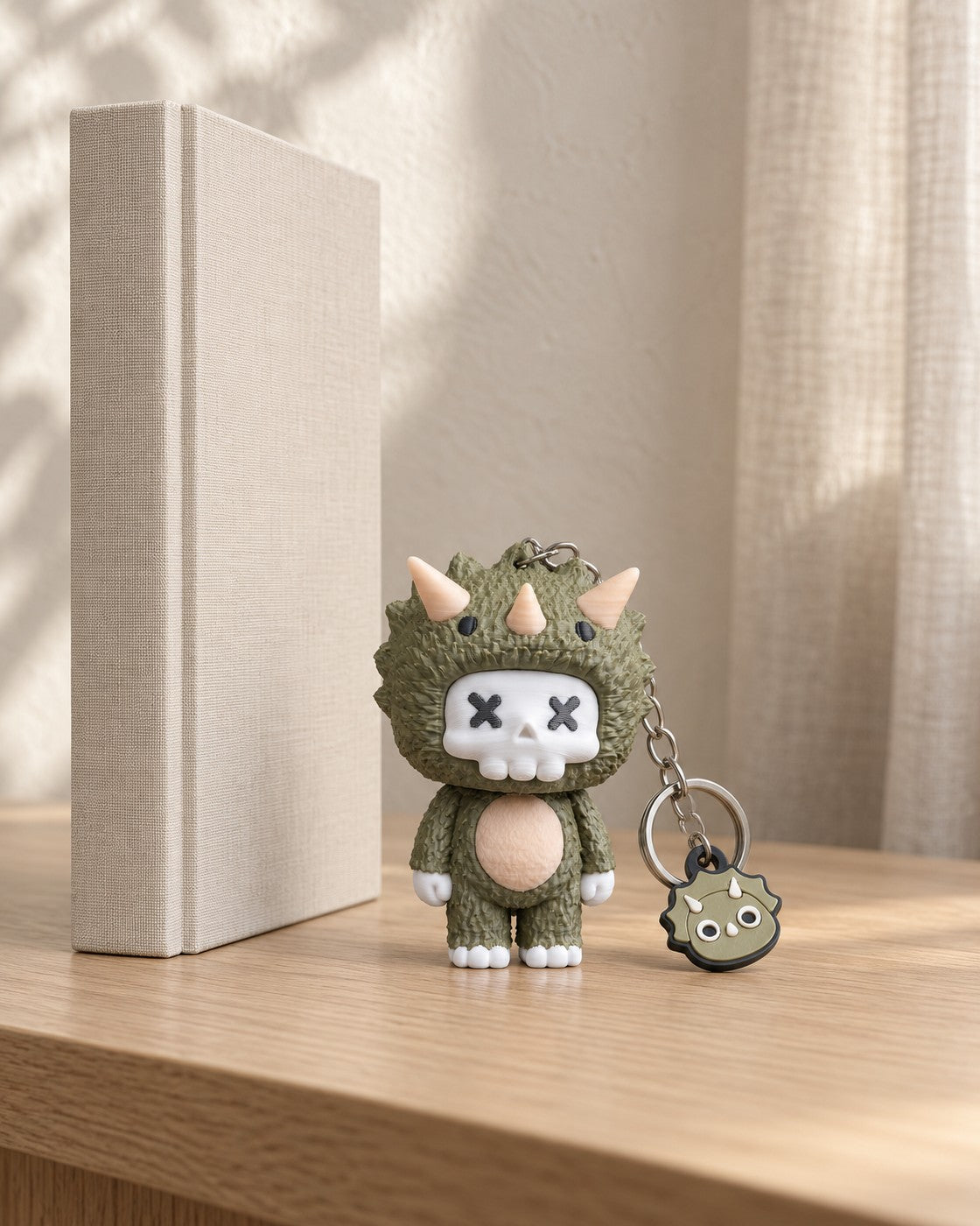 Trixi Skull Keyring in a calm, softly lit interior, shown at true scale
