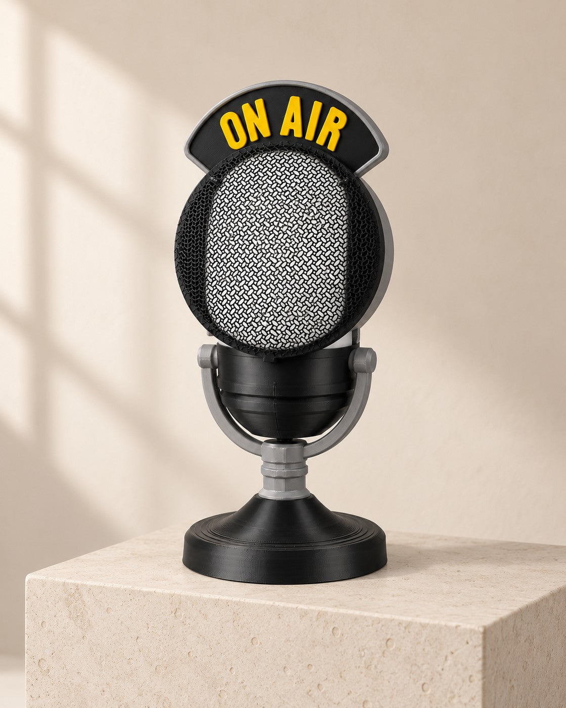 Broadcast Microphone Lamp on a pale limestone plinth, soft studio light