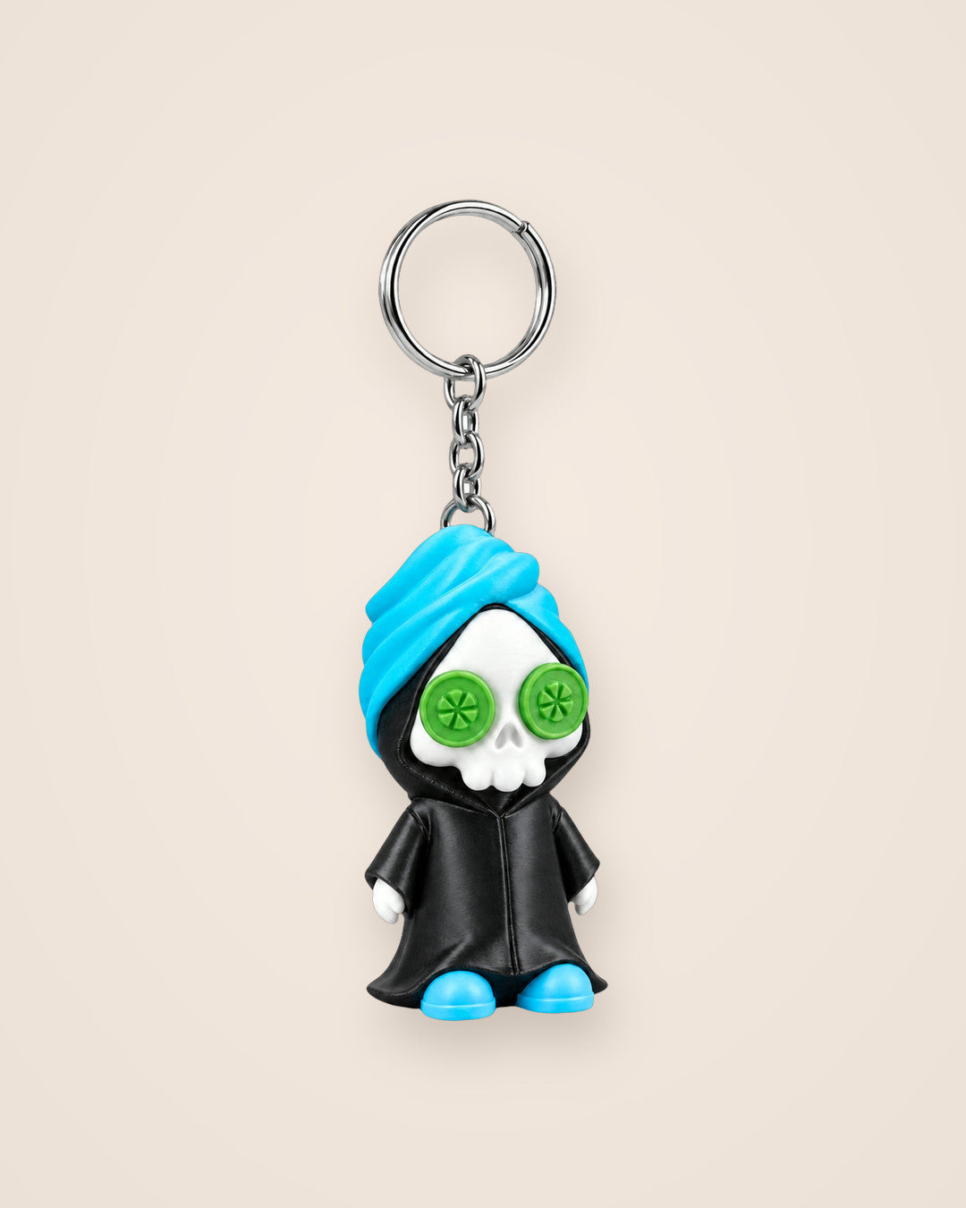 Reap in Peace Keyring: A grim reaper on a spa day, with cucumber eyes, a towel and slippers