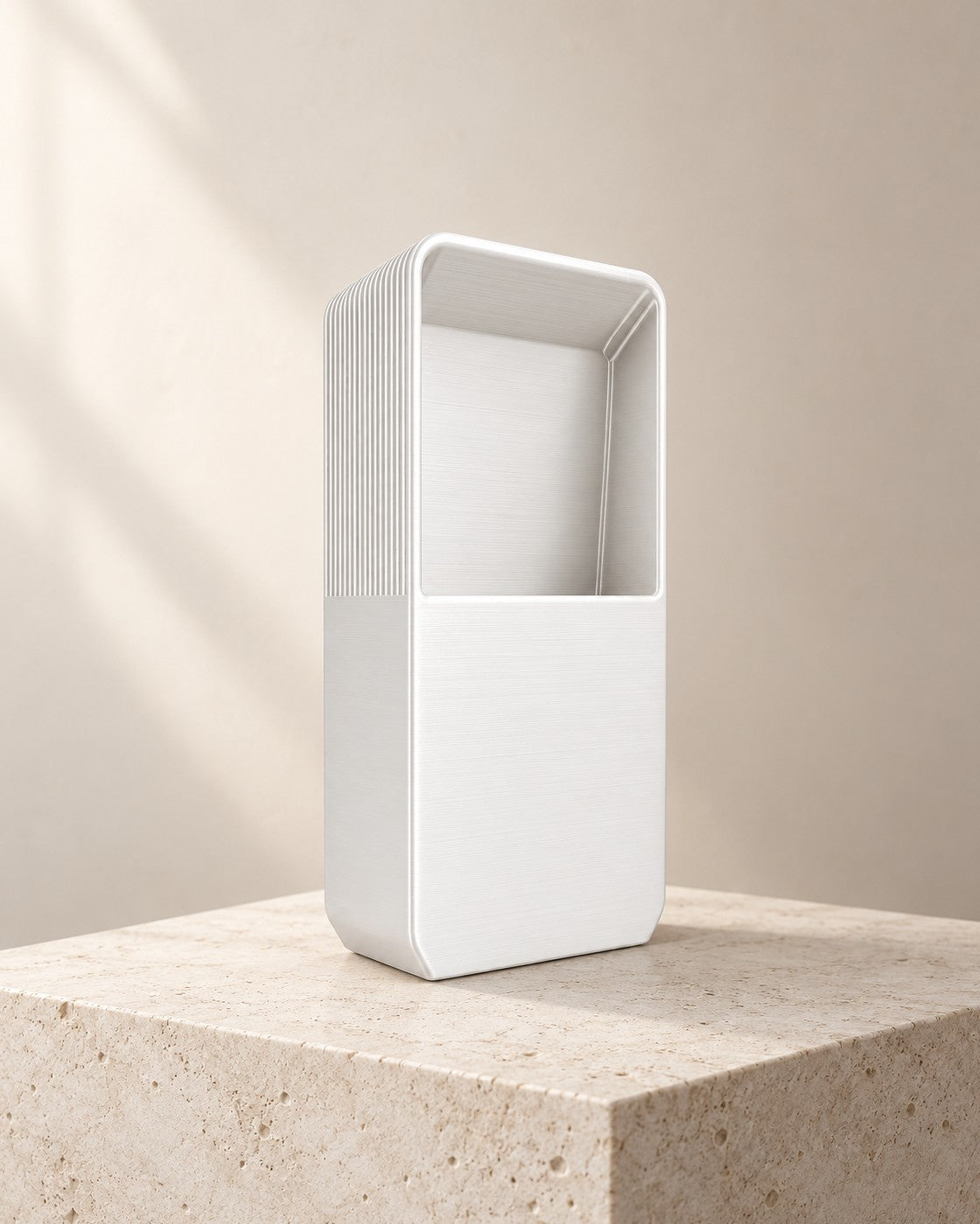 Pocket Headphone Stand on a pale limestone plinth, soft studio light