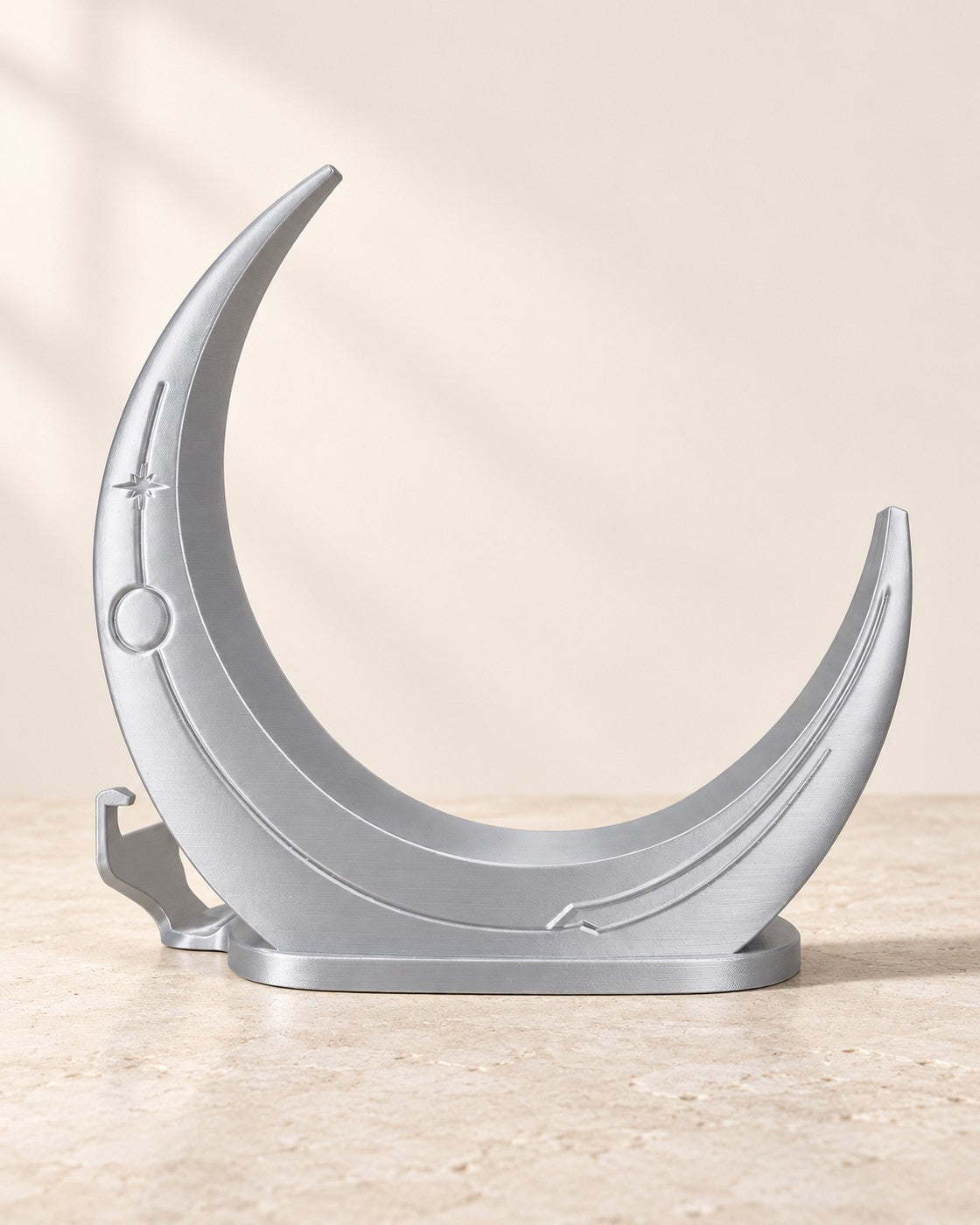Crescent Moon Console Stand on a pale limestone plinth, soft studio light