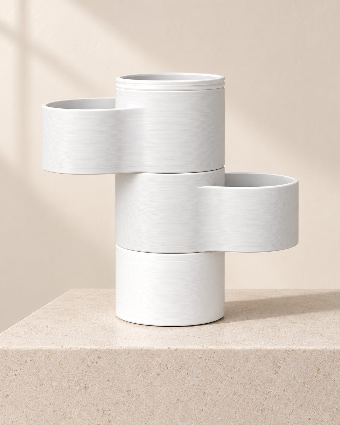 Living Stack Lamp on a pale limestone plinth, soft studio light