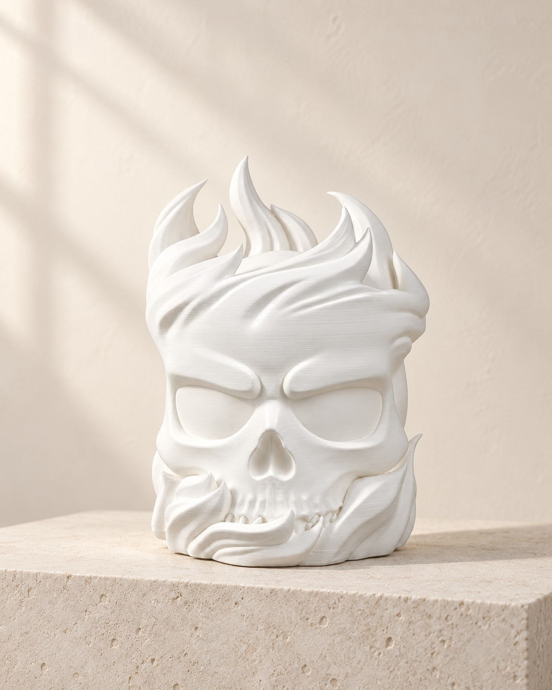 Ember Skull Lamp on a pale limestone plinth, soft studio light