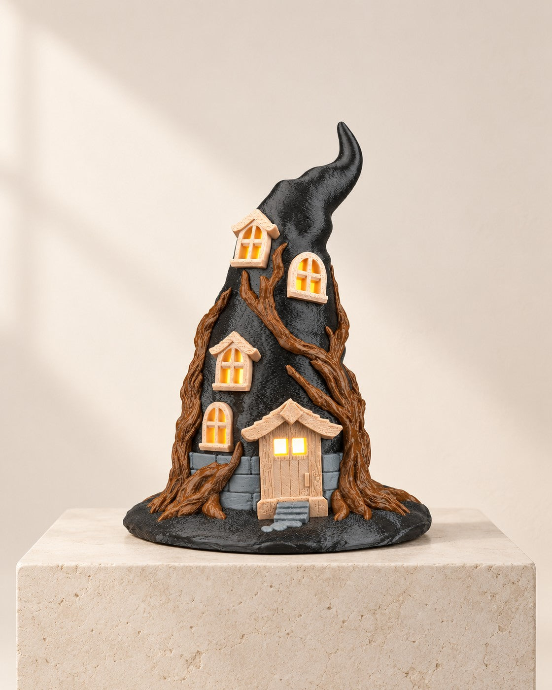 Witch Hat Cottage Lamp on a pale limestone plinth, soft studio light