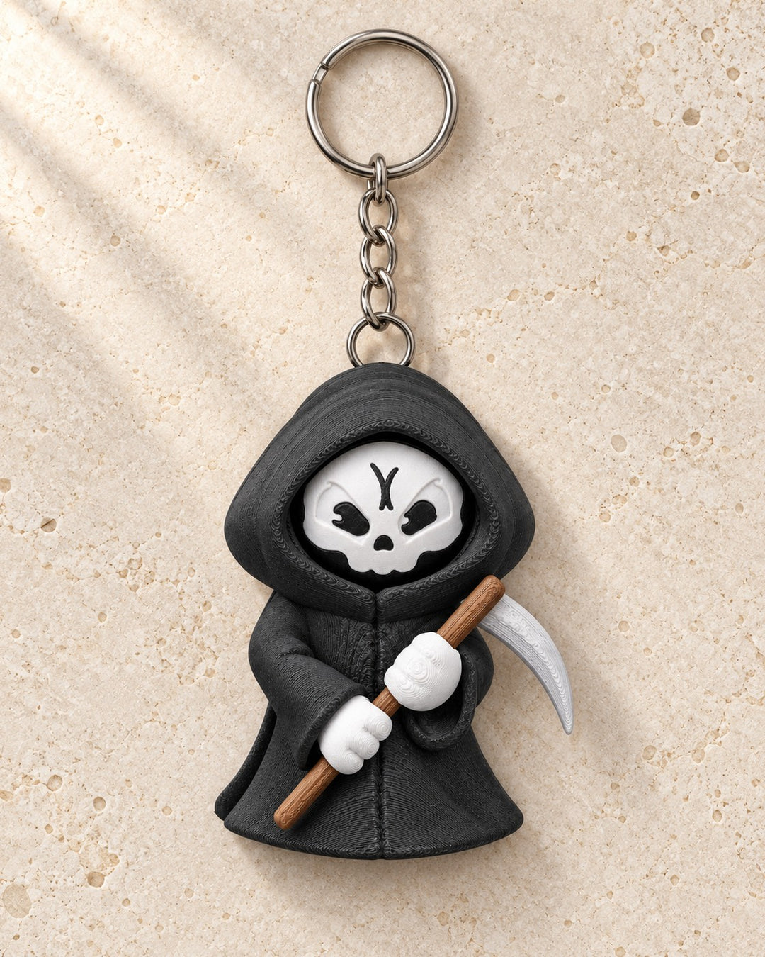 Moody Reaper Keyring: Hooded reaper with a face that turns to show three moods