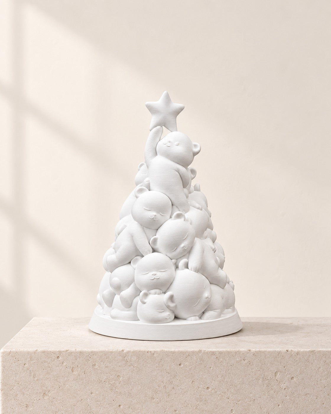 Stacked Bear Christmas Tree on a pale limestone plinth, soft studio light