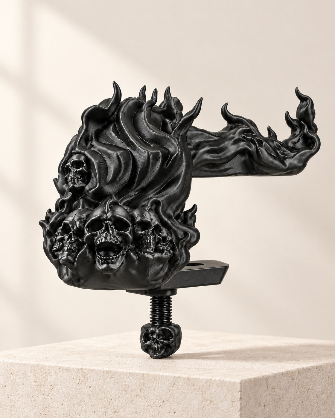 Skull and Flame Headphone Clamp on a pale limestone plinth, soft studio light
