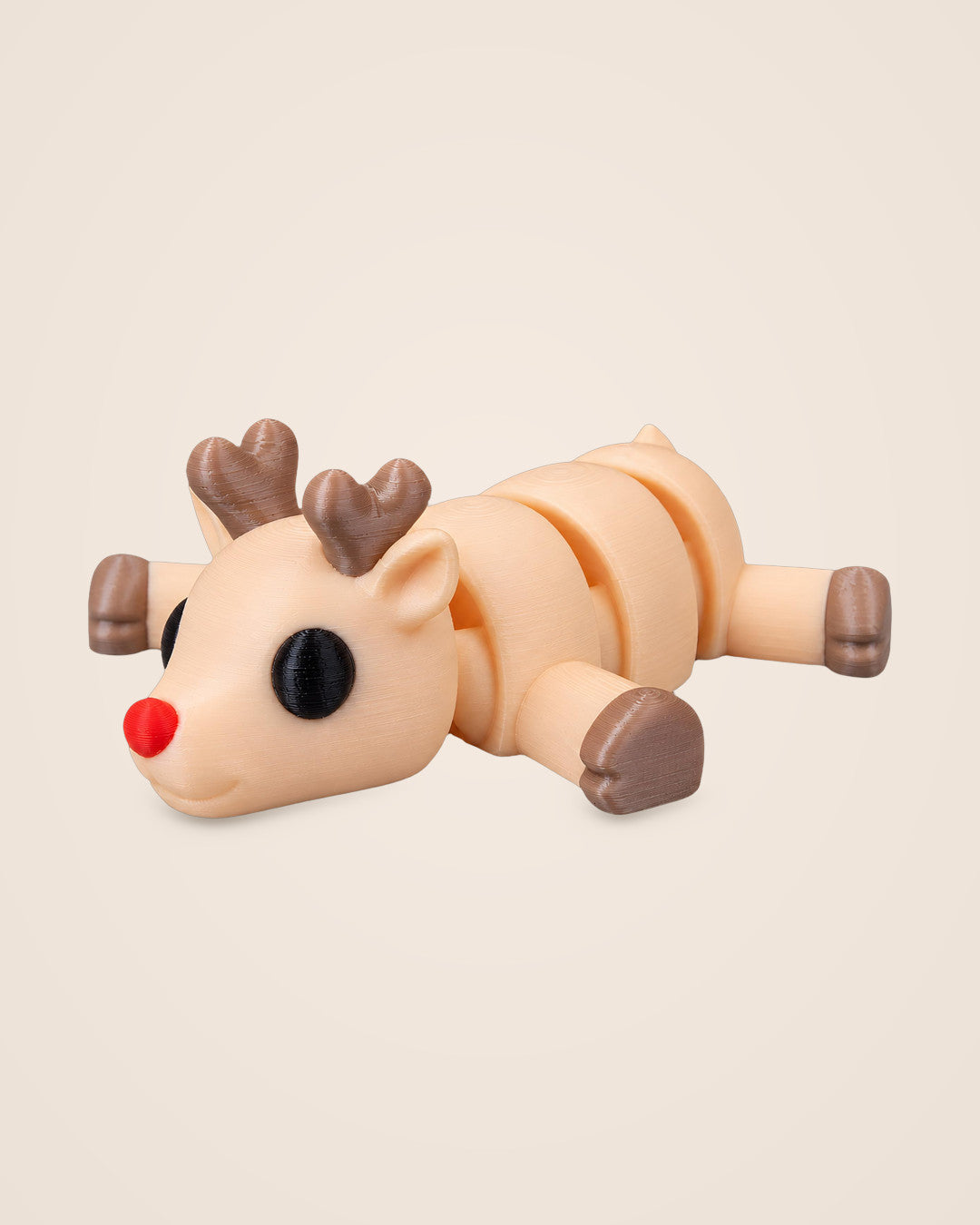 Resting Reindeer Figurine: A cream reindeer flopped flat with a bright red nose