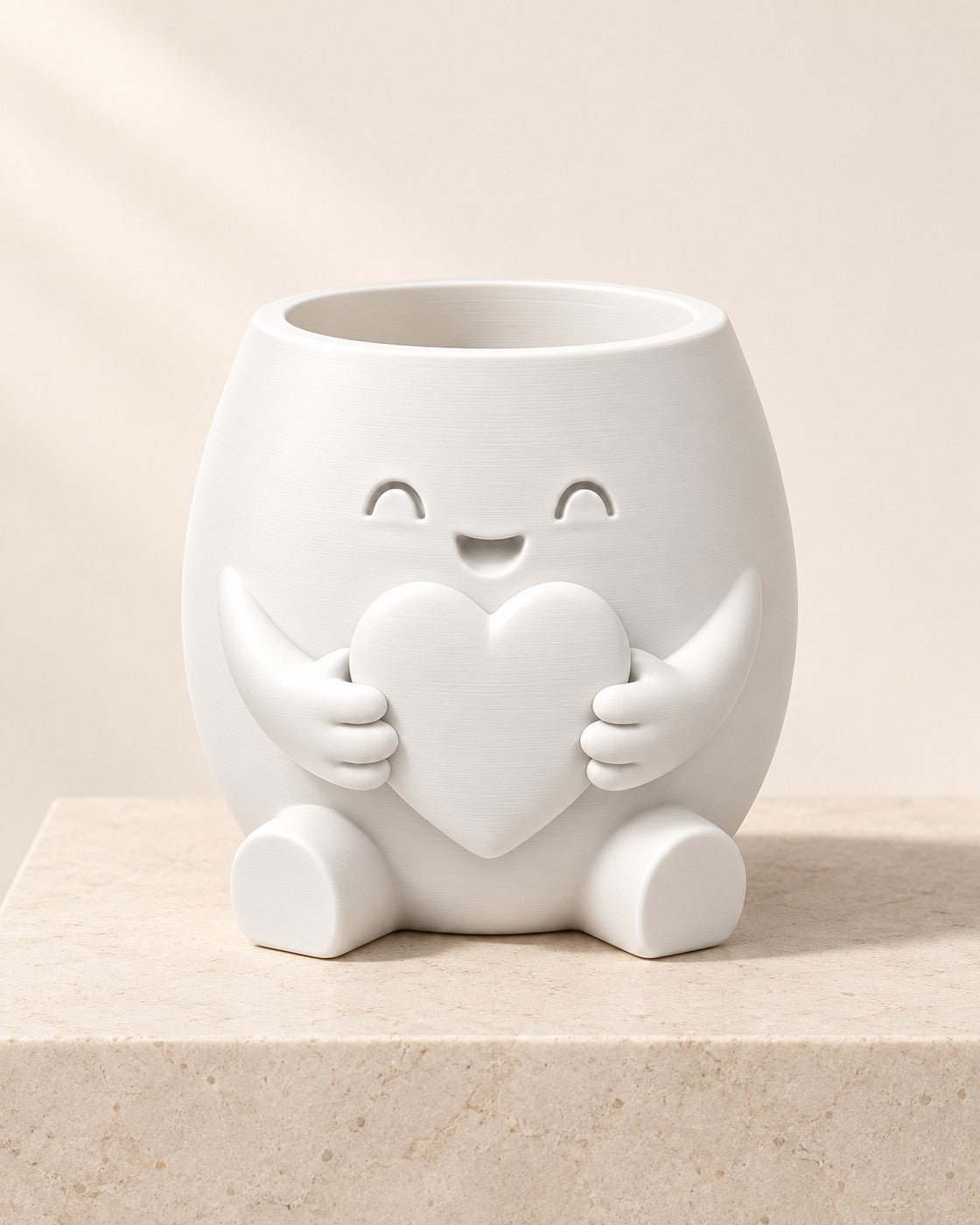 Heart Hug Planter on a pale limestone plinth, soft studio light