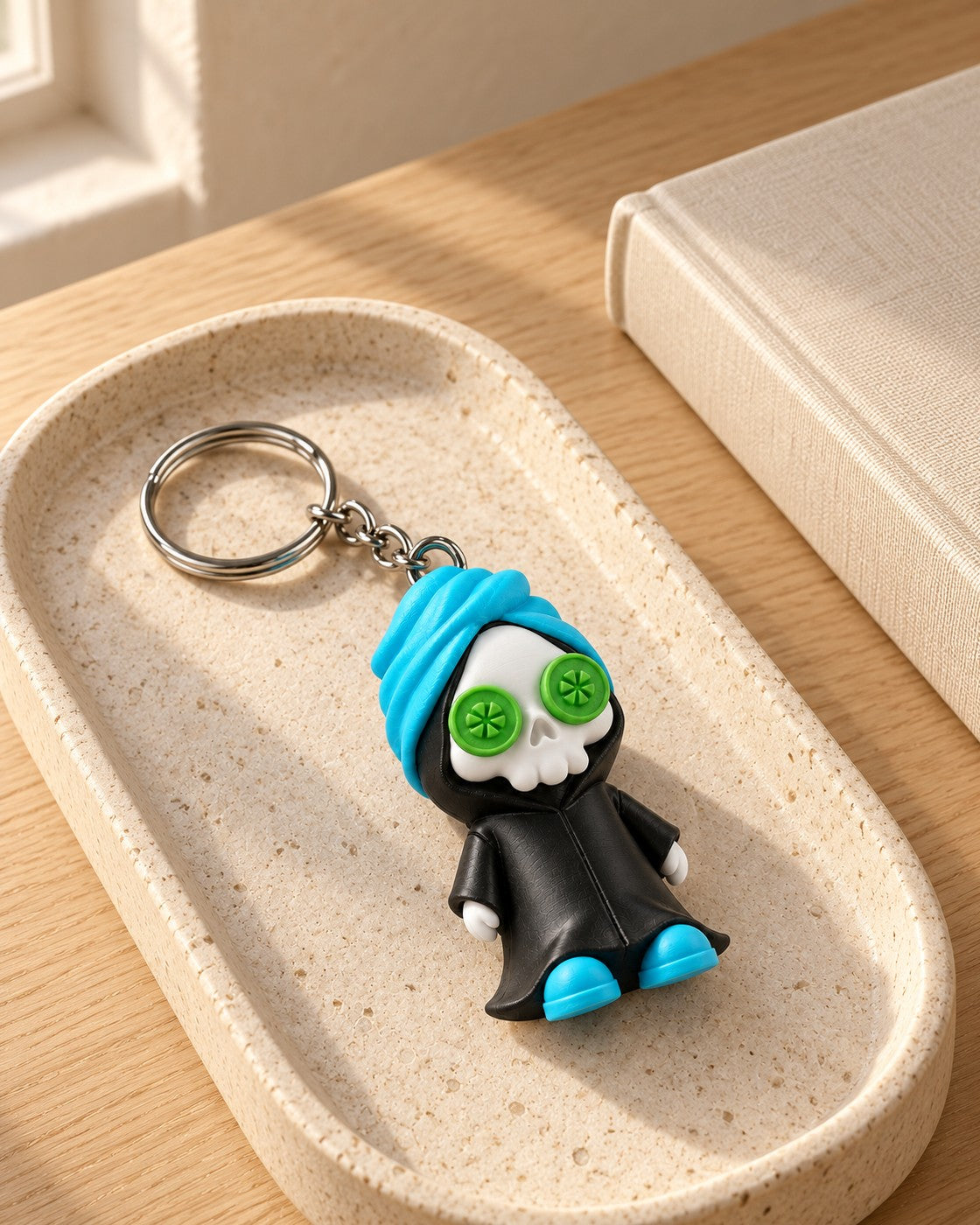 Reap in Peace Keyring in a calm, softly lit interior, shown at true scale