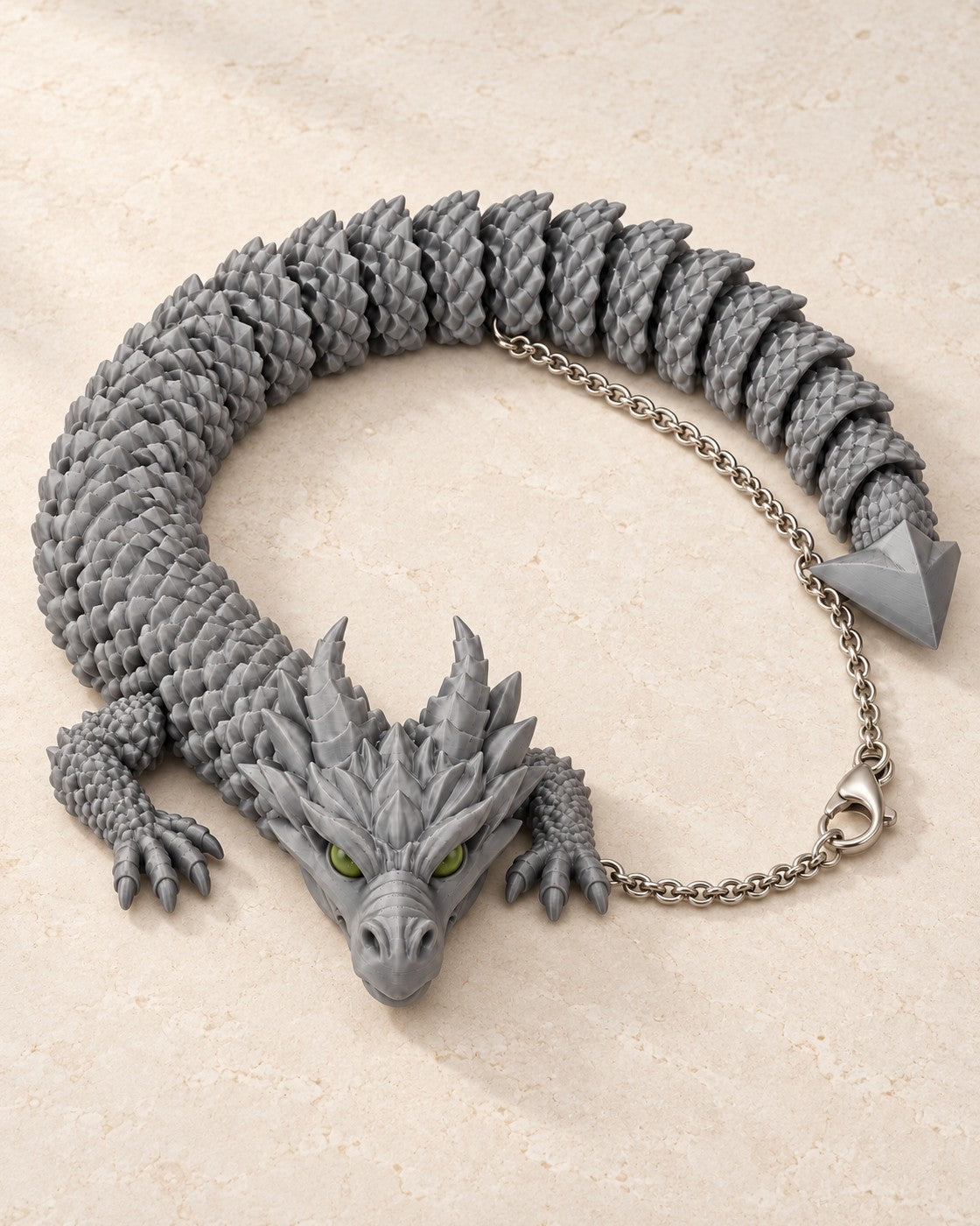 Articulated Dragon Necklace on a pale limestone plinth, soft studio light