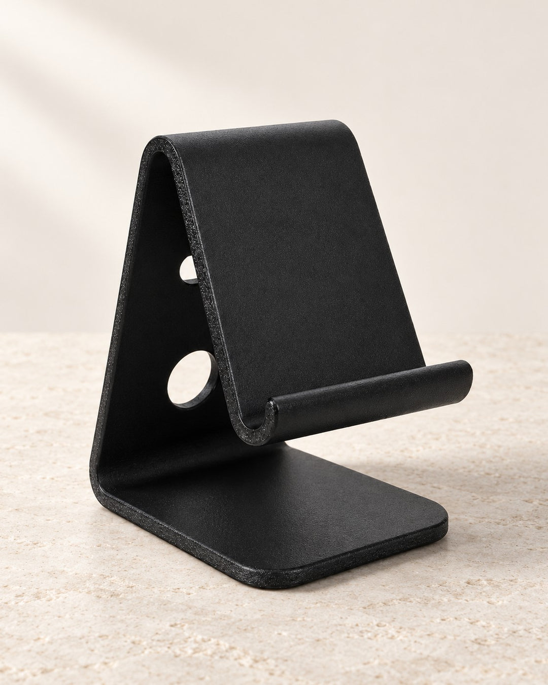 Black Desktop Phone Stand: Compact fixed-angle stand with open front and cable routing