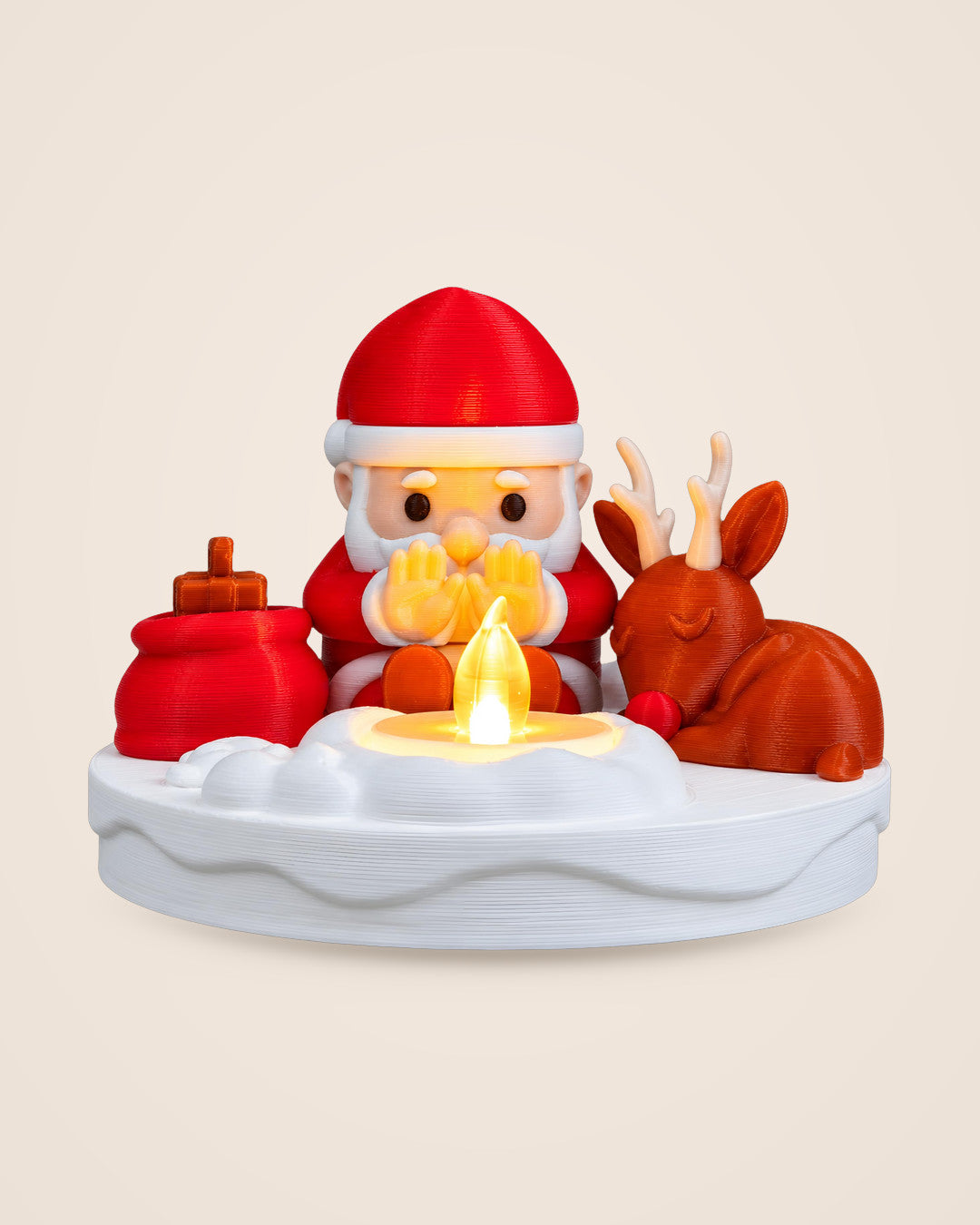 Santa Bonfire Decoration: Santa and a reindeer gathered around a warm-glow LED tealight