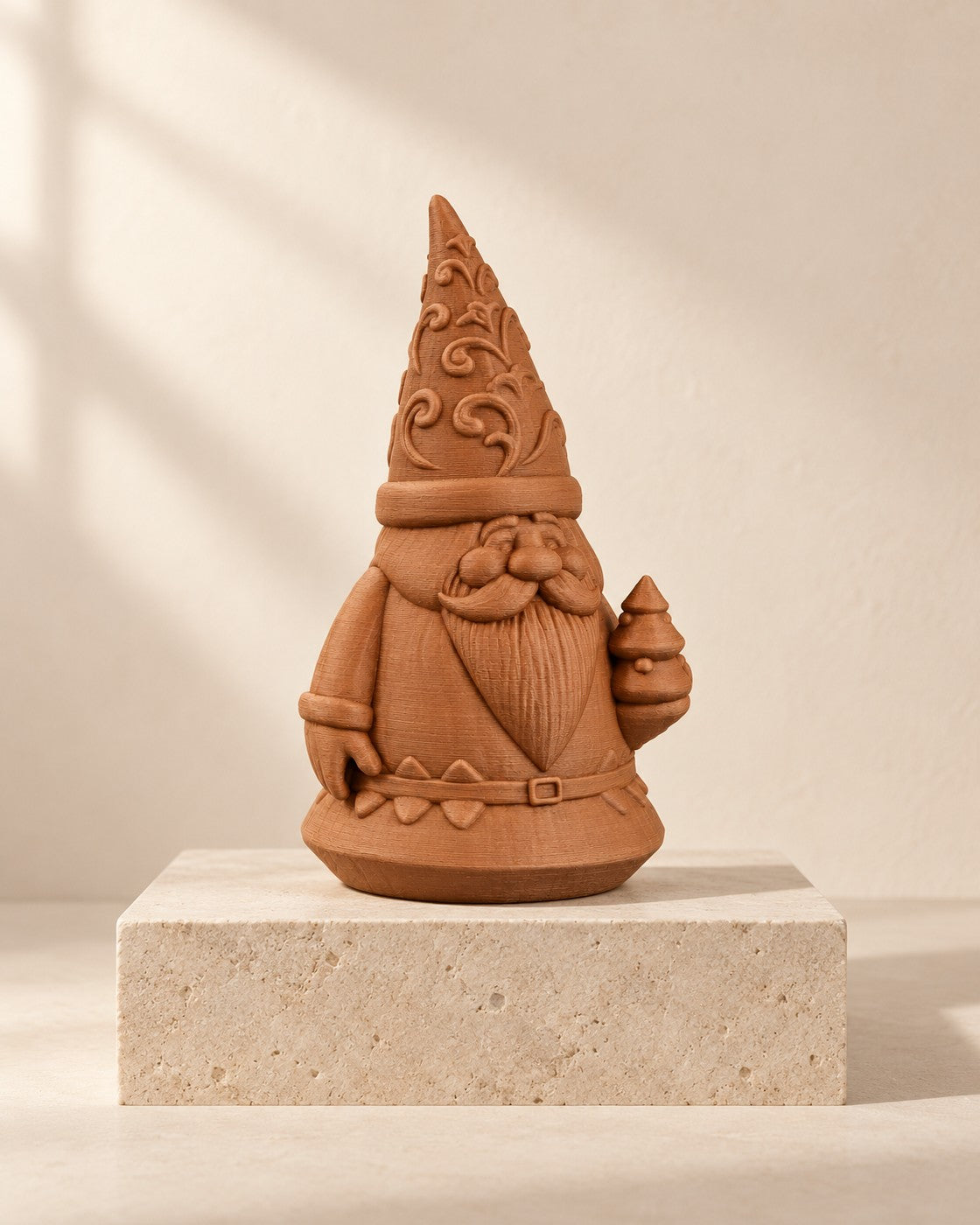 Carved Santa Gnome on a pale limestone plinth, soft studio light