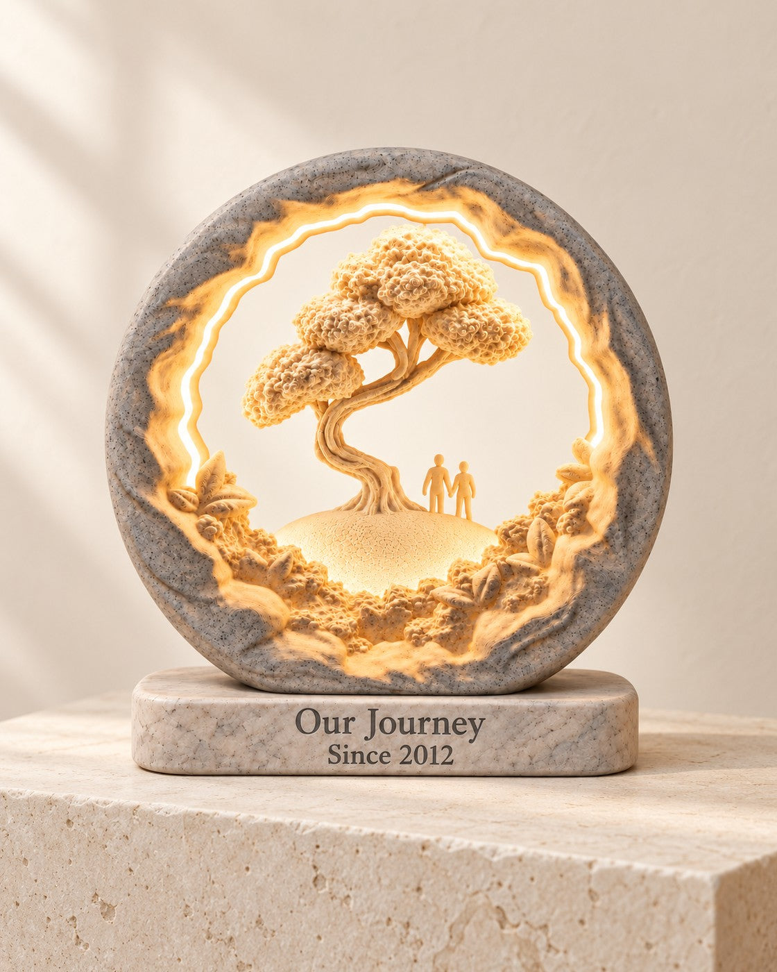Our Journey Personalised Lamp on a pale limestone plinth, soft studio light
