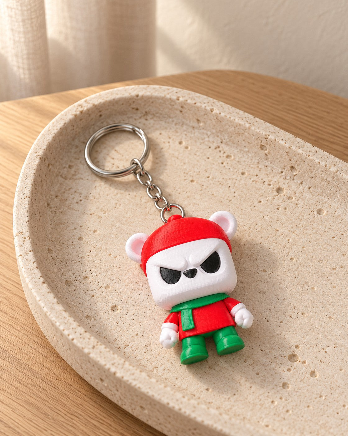 Grumpy Bear Keyring in a calm, softly lit interior, shown at true scale
