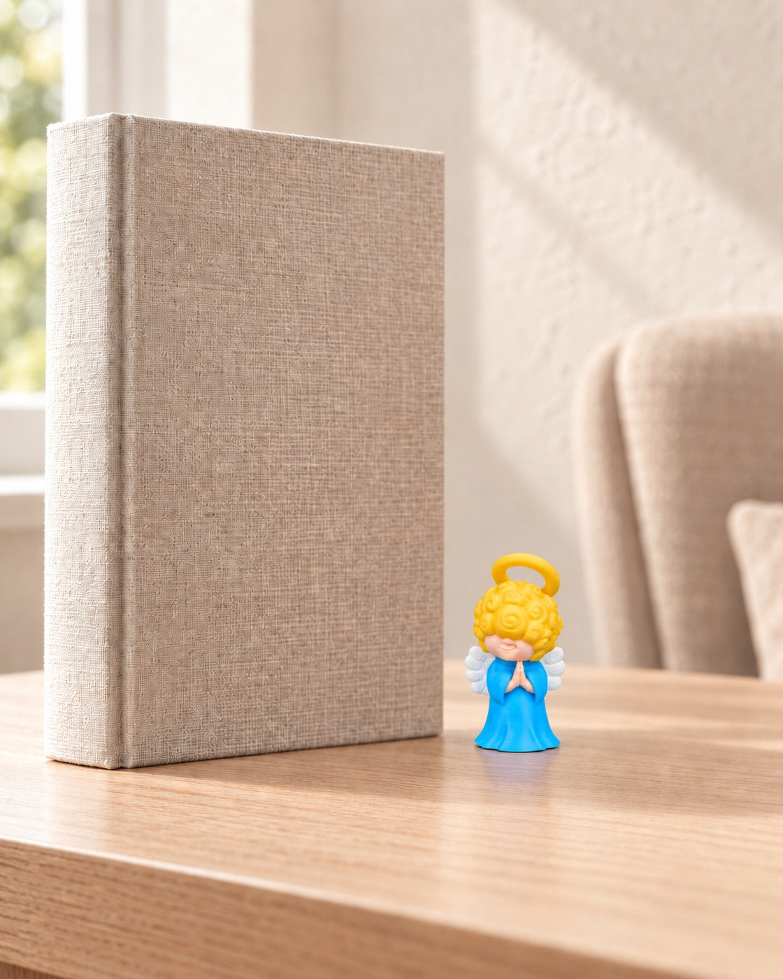 Praying Angel Ornament in a calm, softly lit interior, shown at true scale