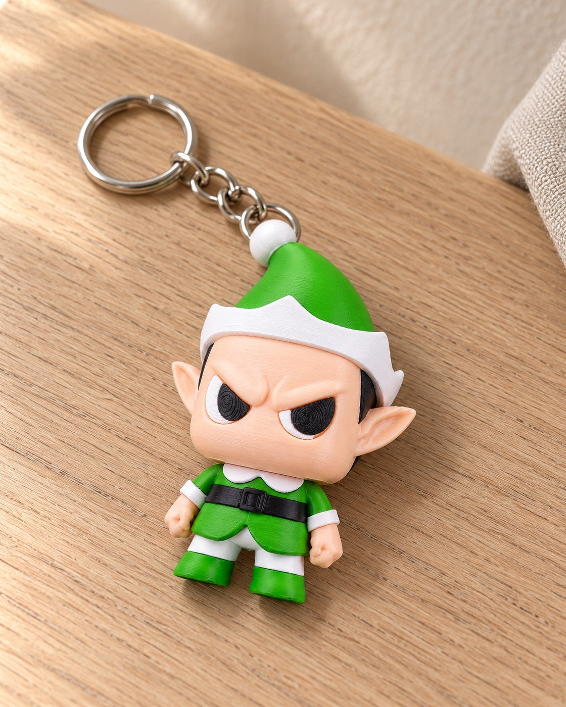 Grumpy Elf Keyring in a calm, softly lit interior, shown at true scale