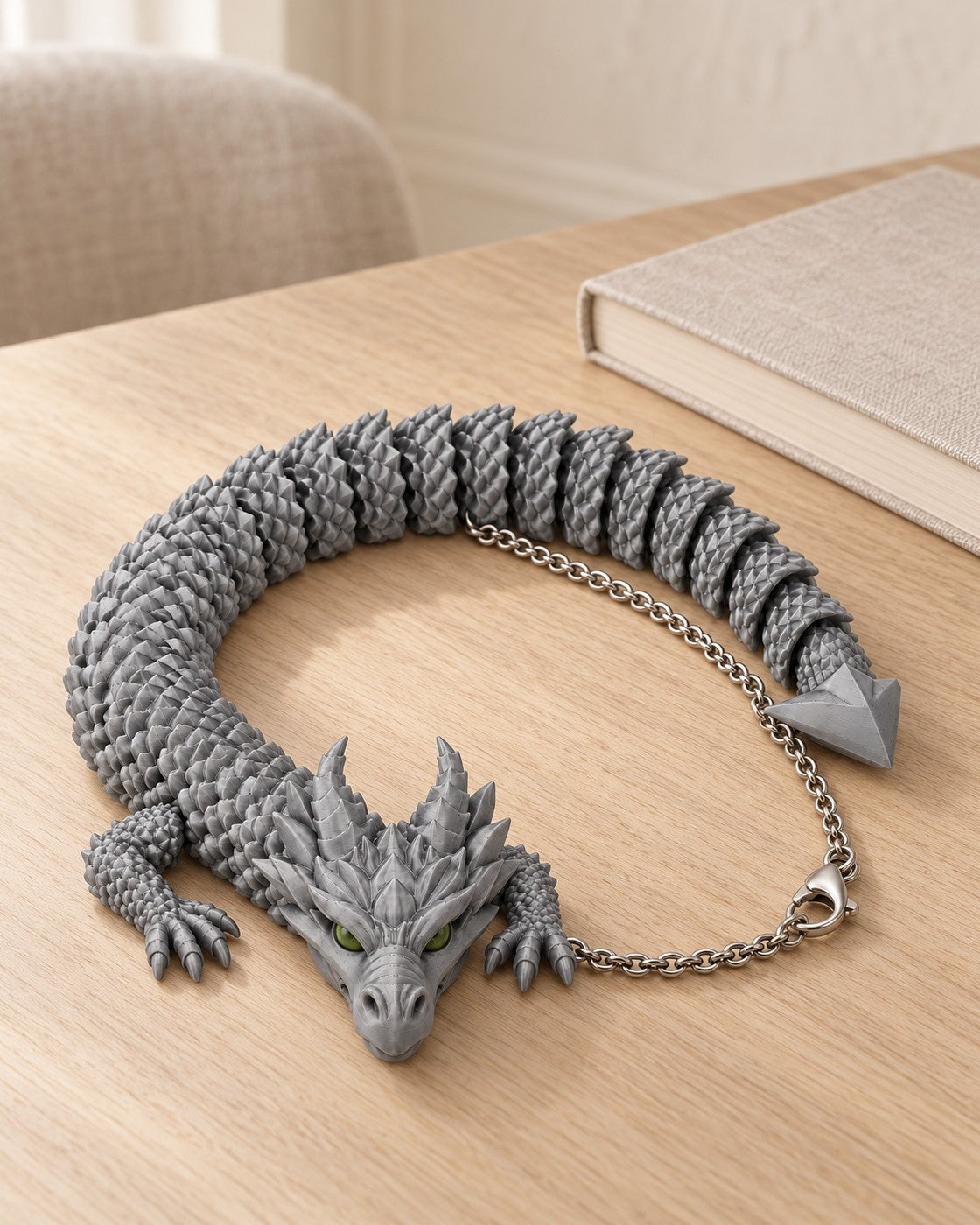 Articulated Dragon Necklace in a calm, softly lit interior, shown at true scale
