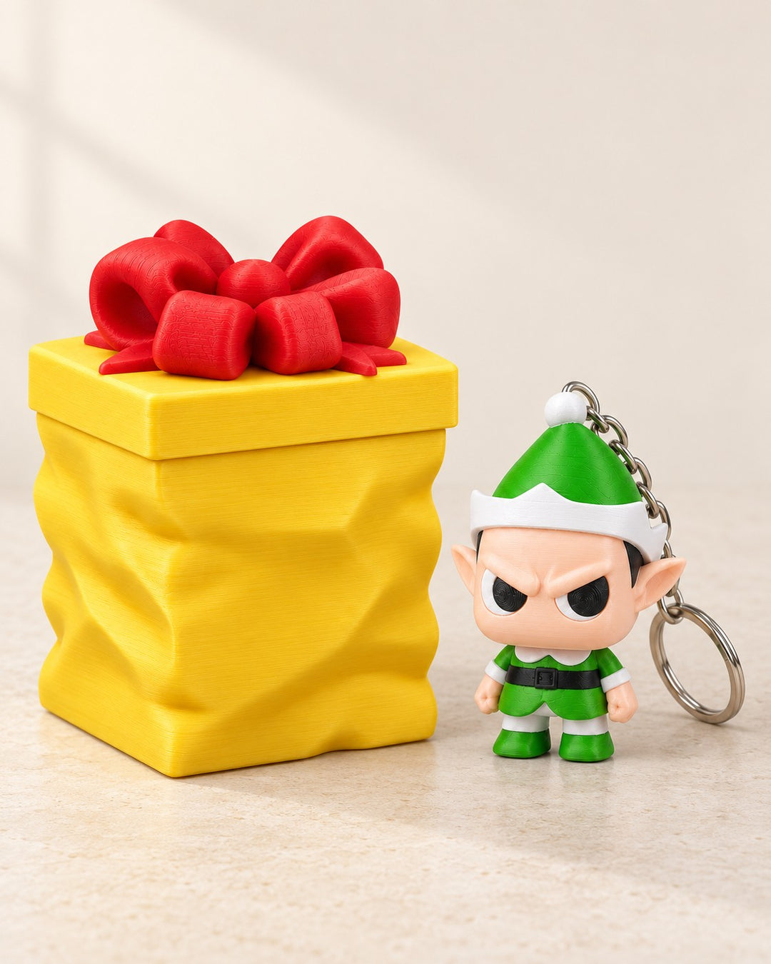 Grumpy Elf with Gift Container: A festive elf keyring with a separate yellow gift container