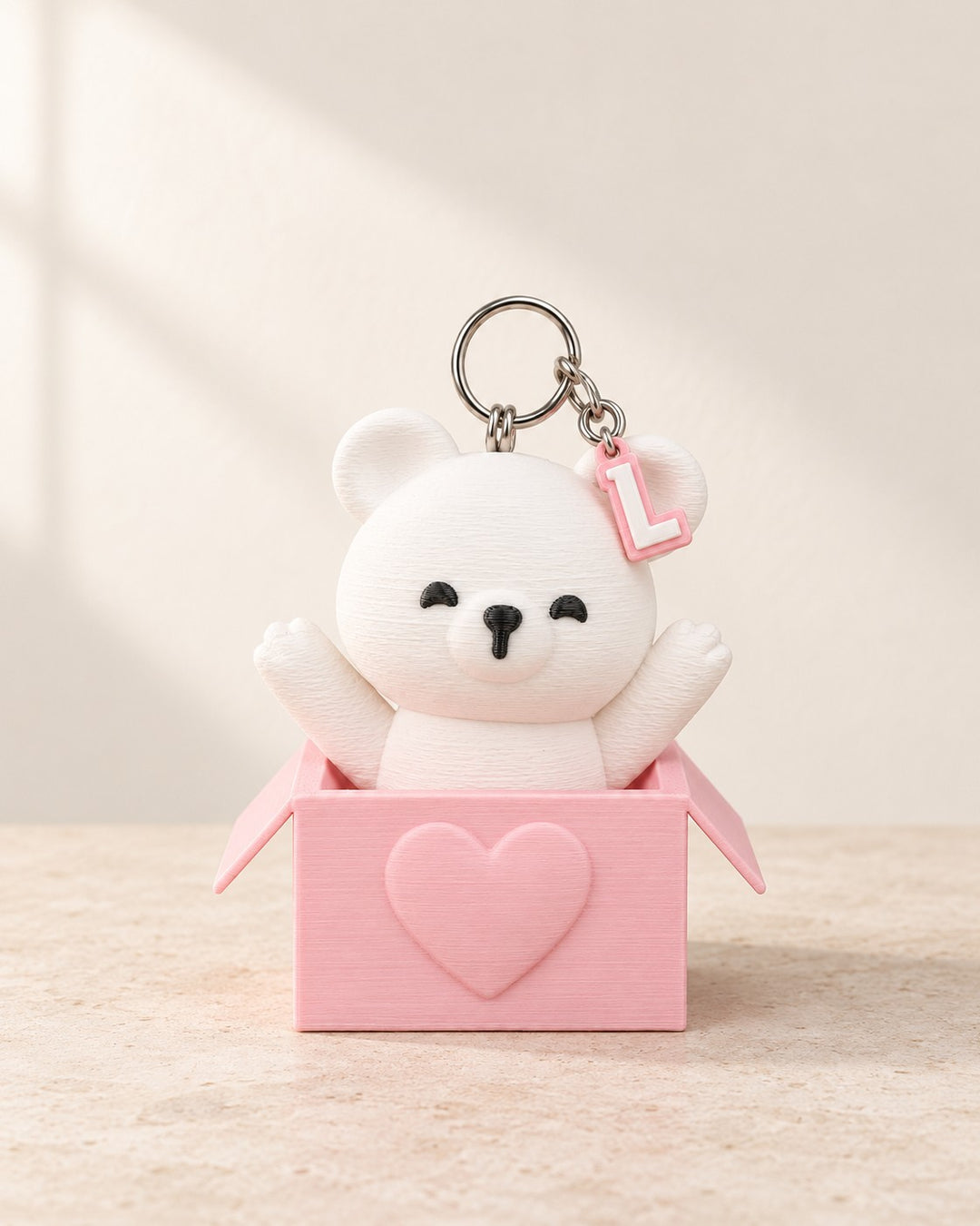 Peek-a-Bear Initial Keyring: White bear peeking from a blush-pink heart box, with your initial