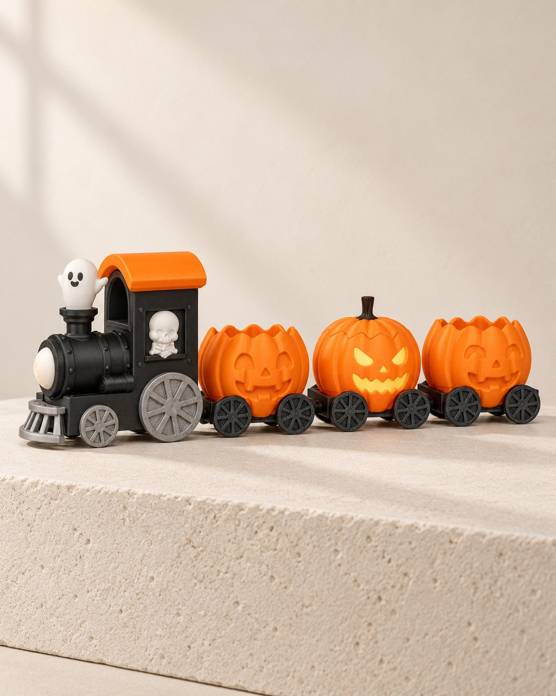 Haunted Pumpkin Train on a pale limestone plinth, soft studio light