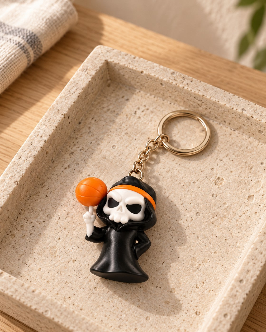 Slam Reaper Keyring in a calm, softly lit interior, shown at true scale