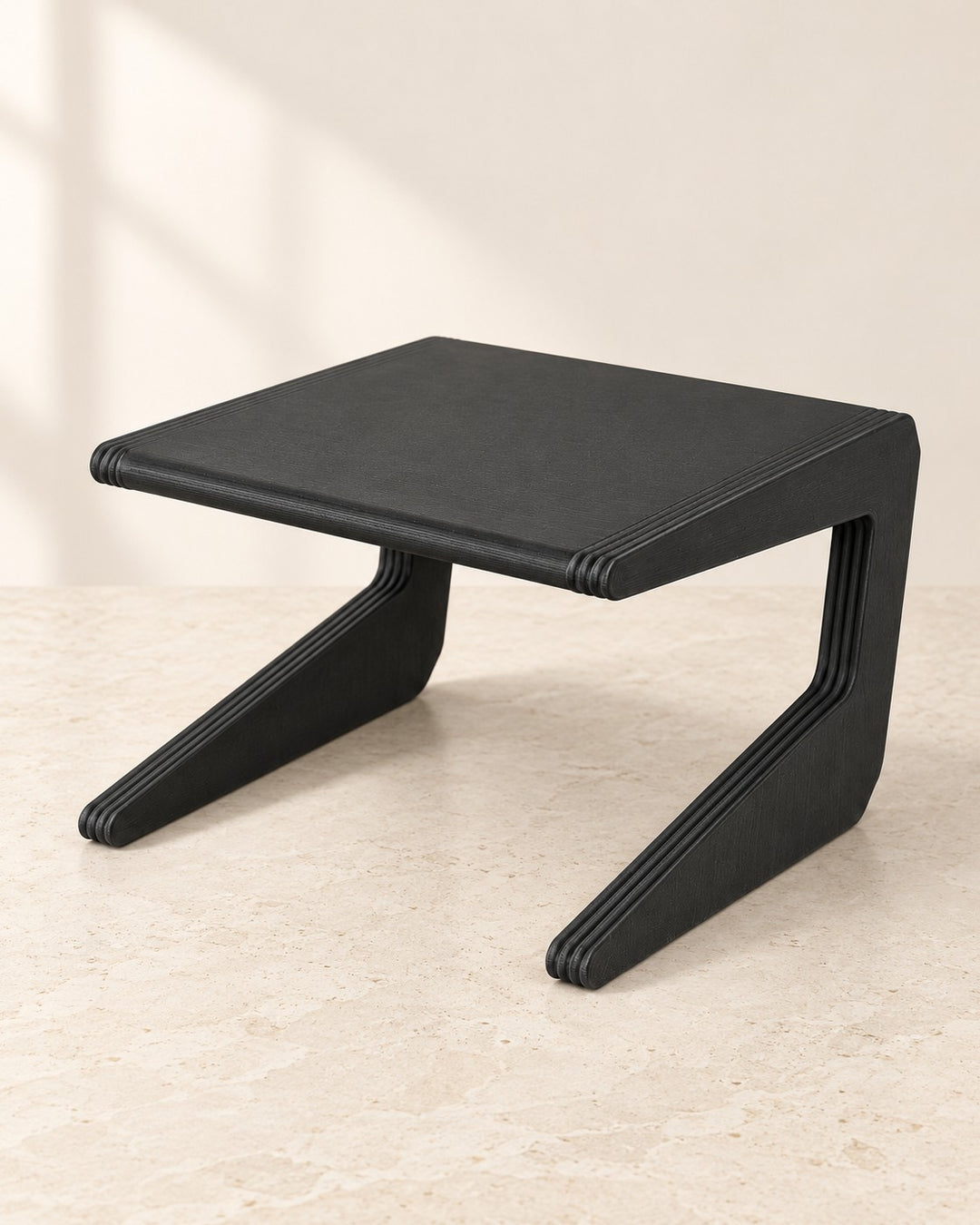 Narrow Shelf Riser: One-piece matte black riser for cupboard shelves