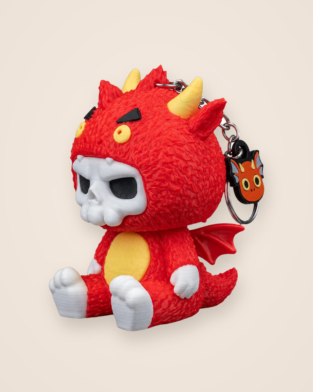 Dragon Skull Keyring: A small red dragon character with a white skull face