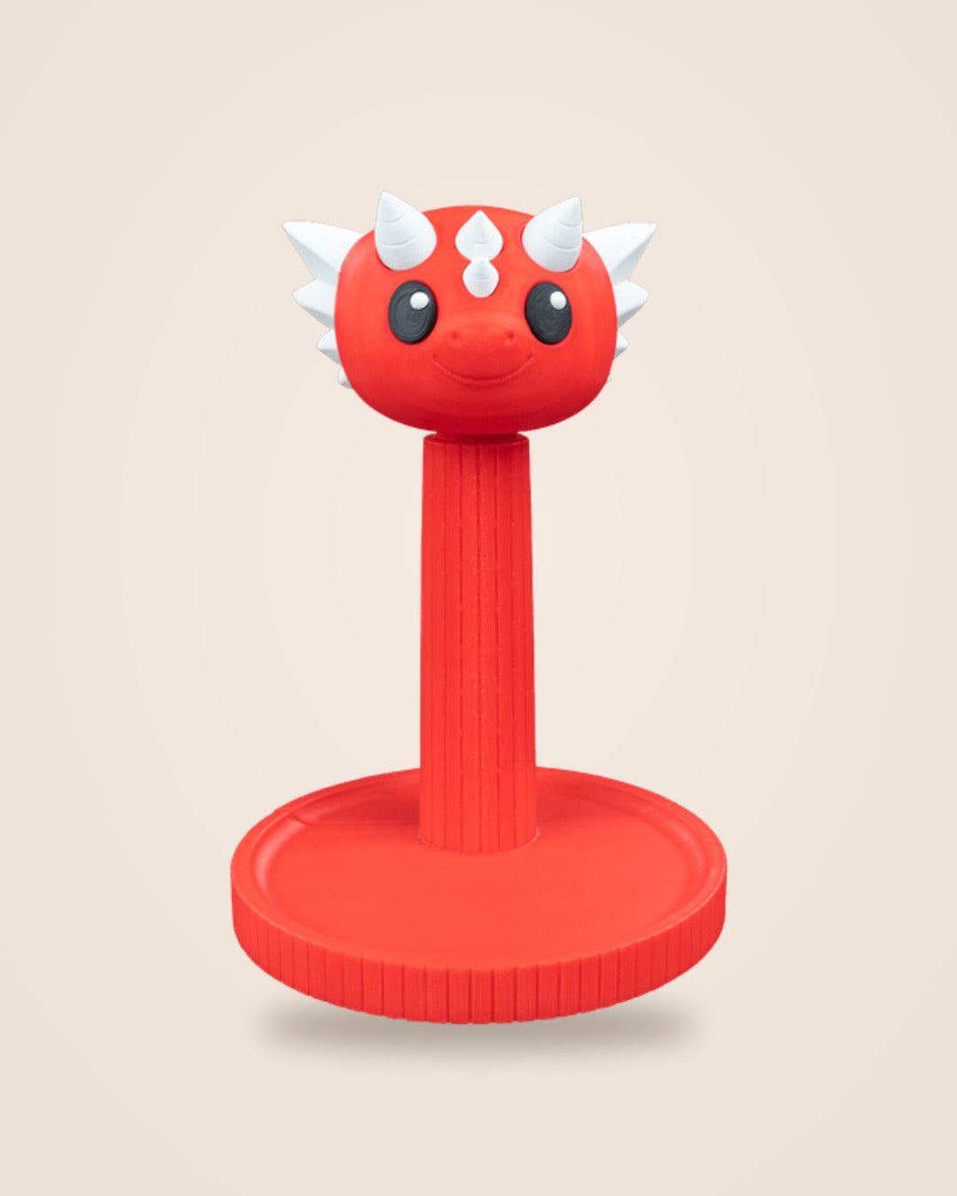 Red dragon headphone stand with white horns and black eyes, front view on a cream background