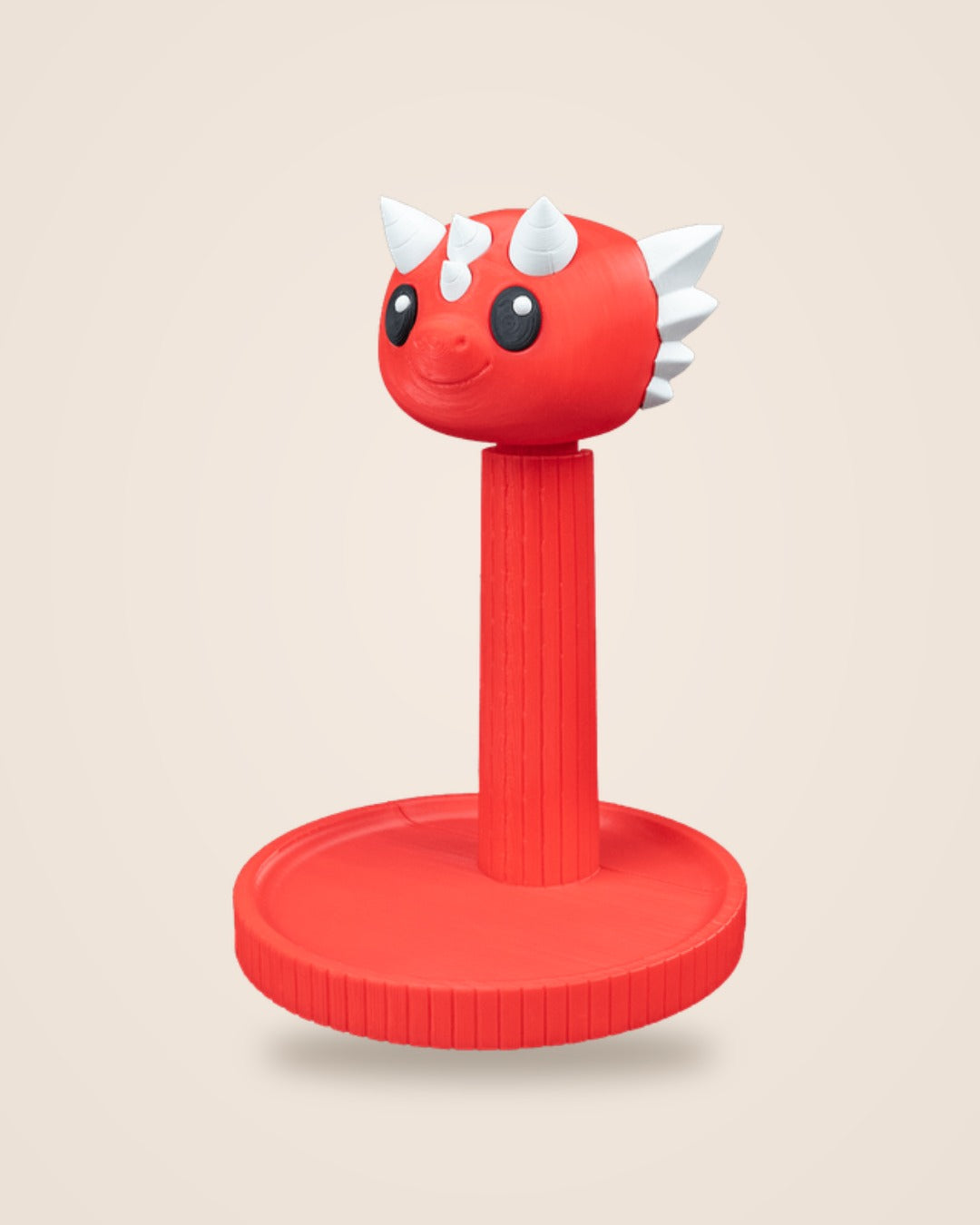 Red dragon headphone stand with white horns, three-quarter view showing the smiling face and white spines