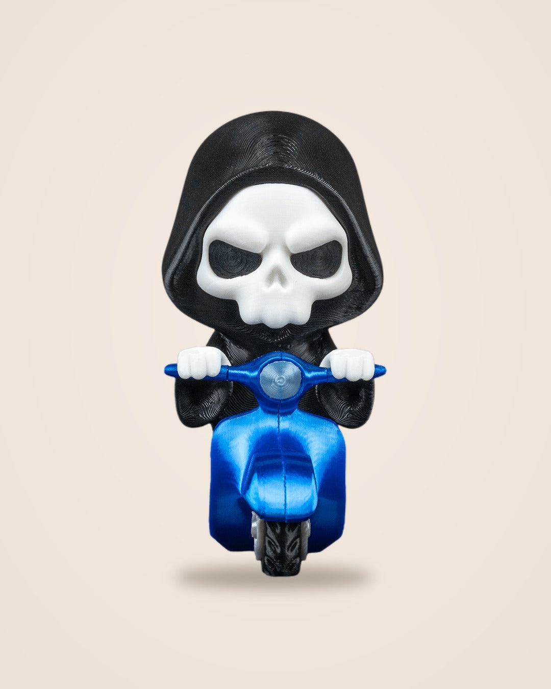 Front view of a hooded Grim Reaper figurine with a white skull gripping the handlebars of a blue scooter